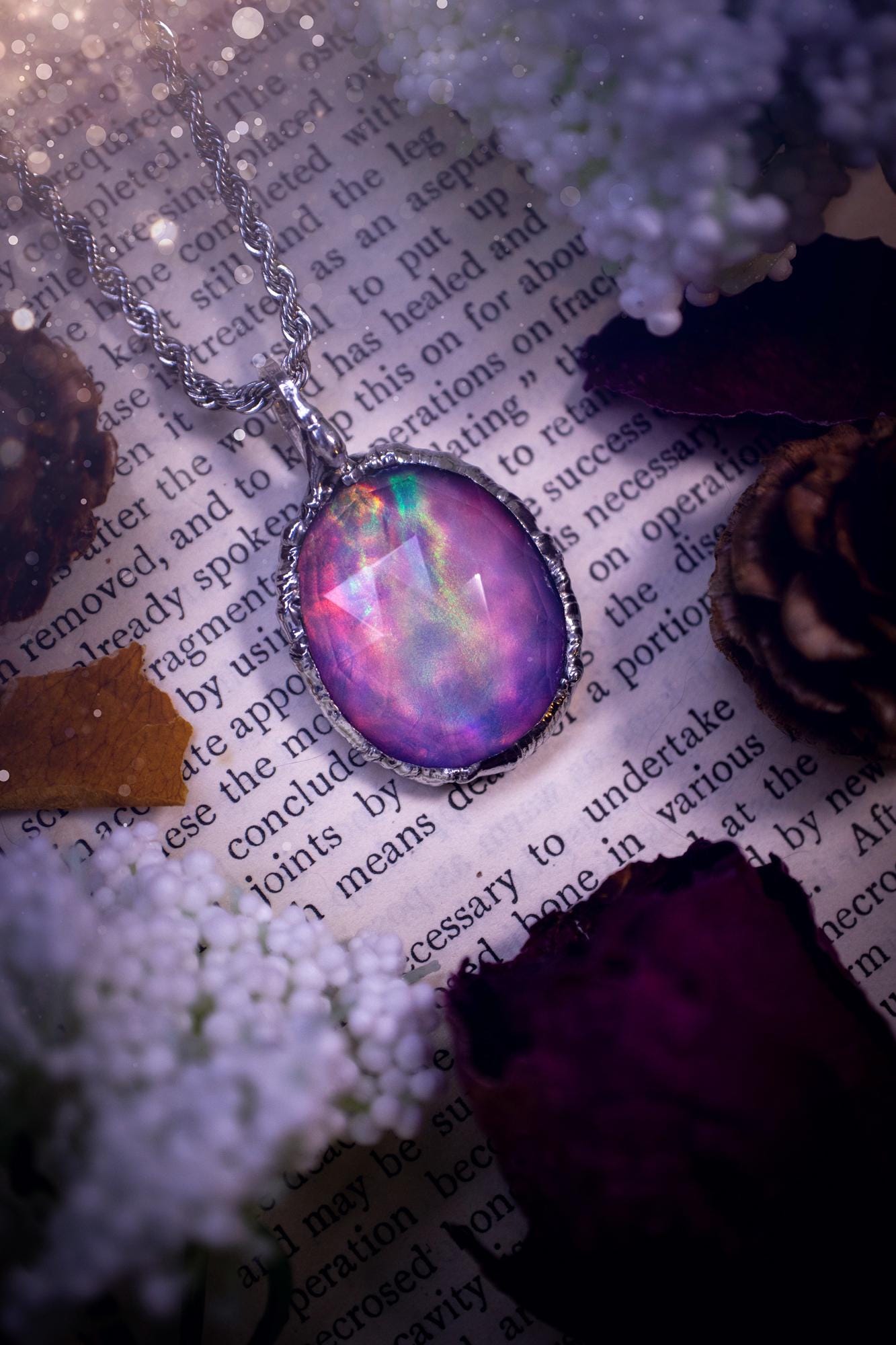 A beautiful, one of a kind, aurora opal pendant necklace. This little statement necklace is handmade using the tiffany technique, also known as soft soldering. Featuring the most stunning, and sparkly aurora opal which is full of pinks, greens and blues just like the northern lights. Aurora opals are man made opals that look similar to natural ones, they have a layer of rose quartz on top to give extra shine. The ideal gift for any crystal or jewellery lover. Gothic and witchy jewellery