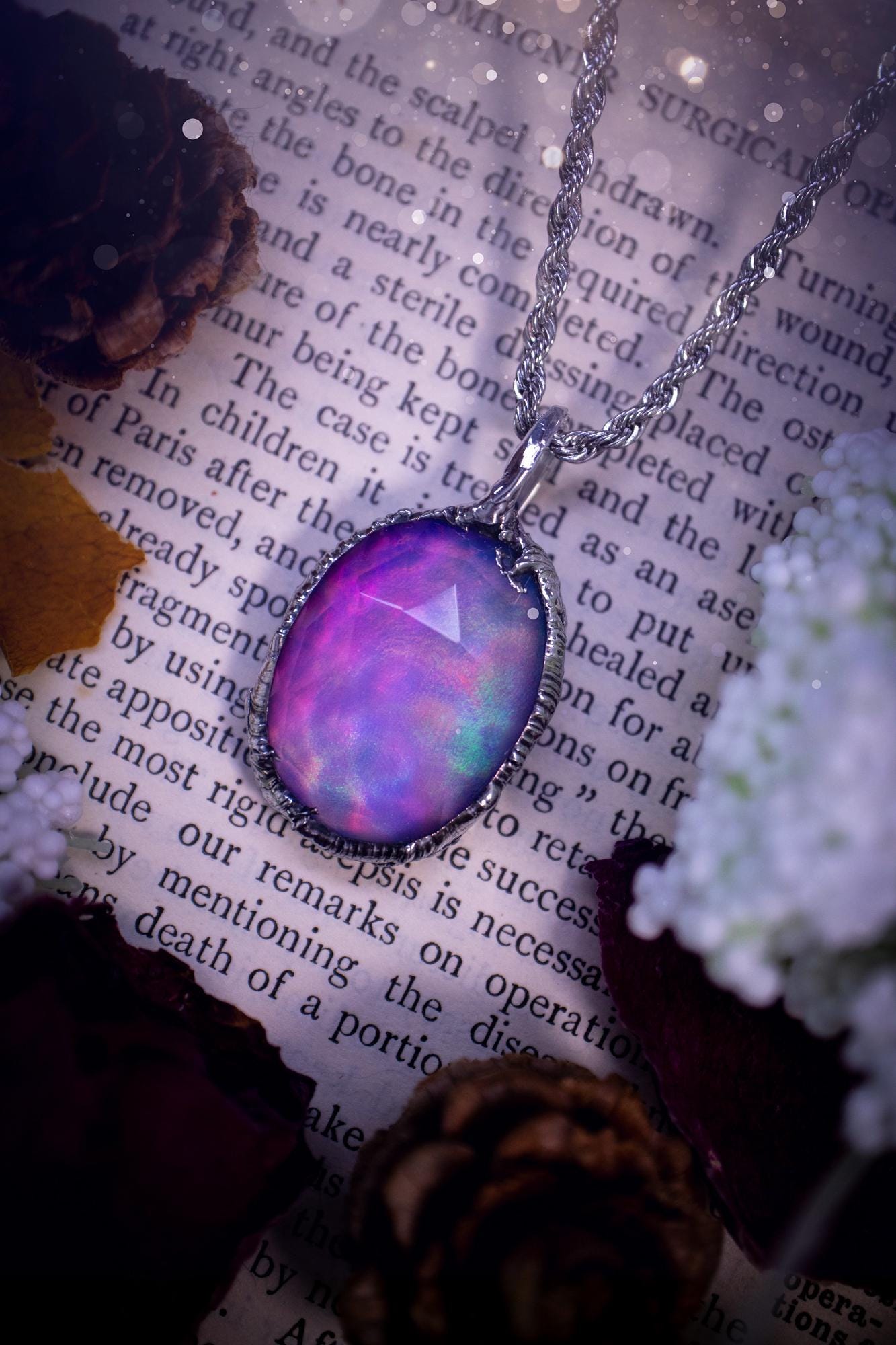 A beautiful, one of a kind, aurora opal pendant necklace. This little statement necklace is handmade using the tiffany technique, also known as soft soldering. Featuring the most stunning, and sparkly aurora opal which is full of pinks, greens and blues just like the northern lights. Aurora opals are man made opals that look similar to natural ones, they have a layer of rose quartz on top to give extra shine. The ideal gift for any crystal or jewellery lover. Gothic and witchy jewellery