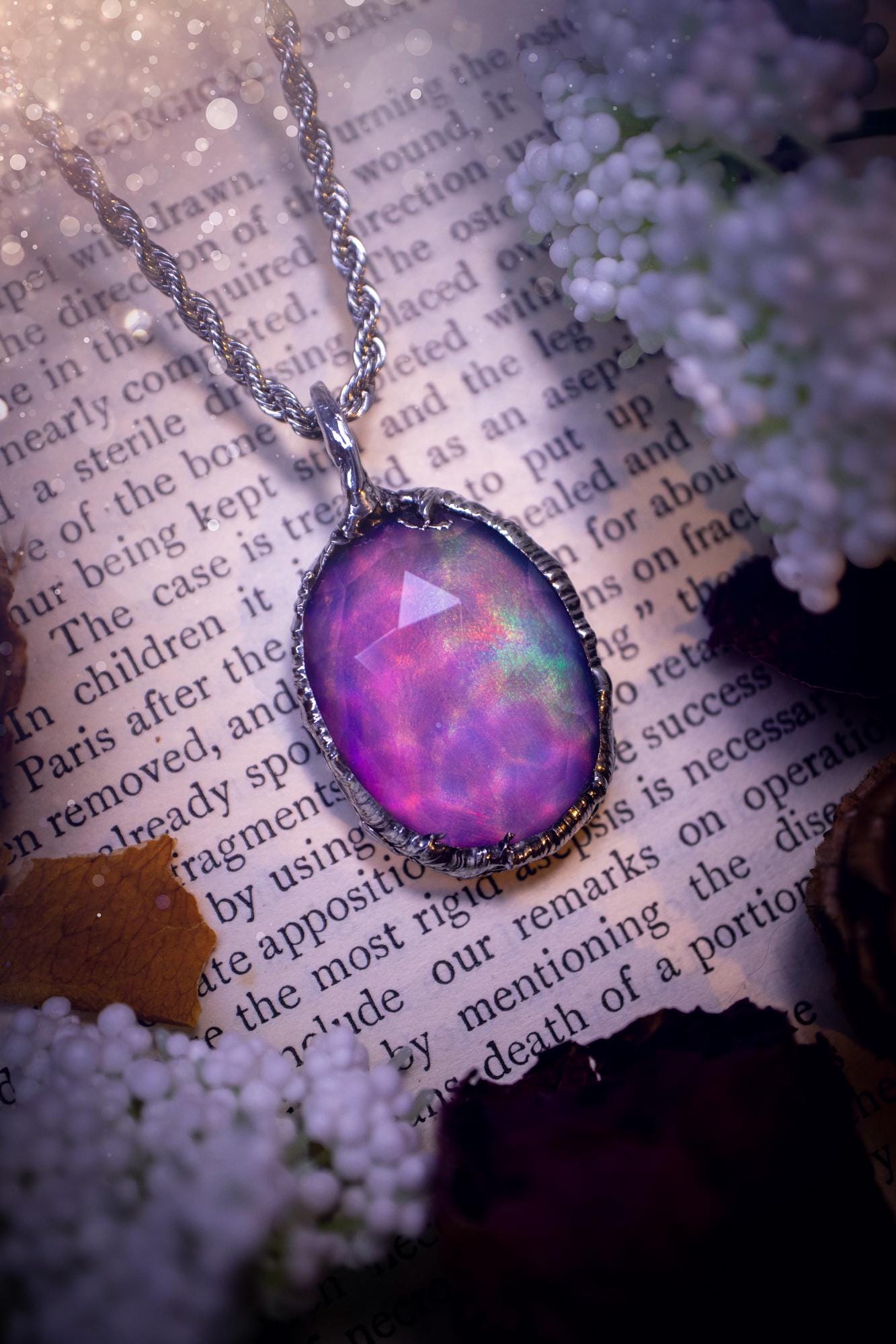 A beautiful, one of a kind, aurora opal pendant necklace. This little statement necklace is handmade using the tiffany technique, also known as soft soldering. Featuring the most stunning, and sparkly aurora opal which is full of pinks, greens and blues just like the northern lights. Aurora opals are man made opals that look similar to natural ones, they have a layer of rose quartz on top to give extra shine. The ideal gift for any crystal or jewellery lover. Gothic and witchy jewellery