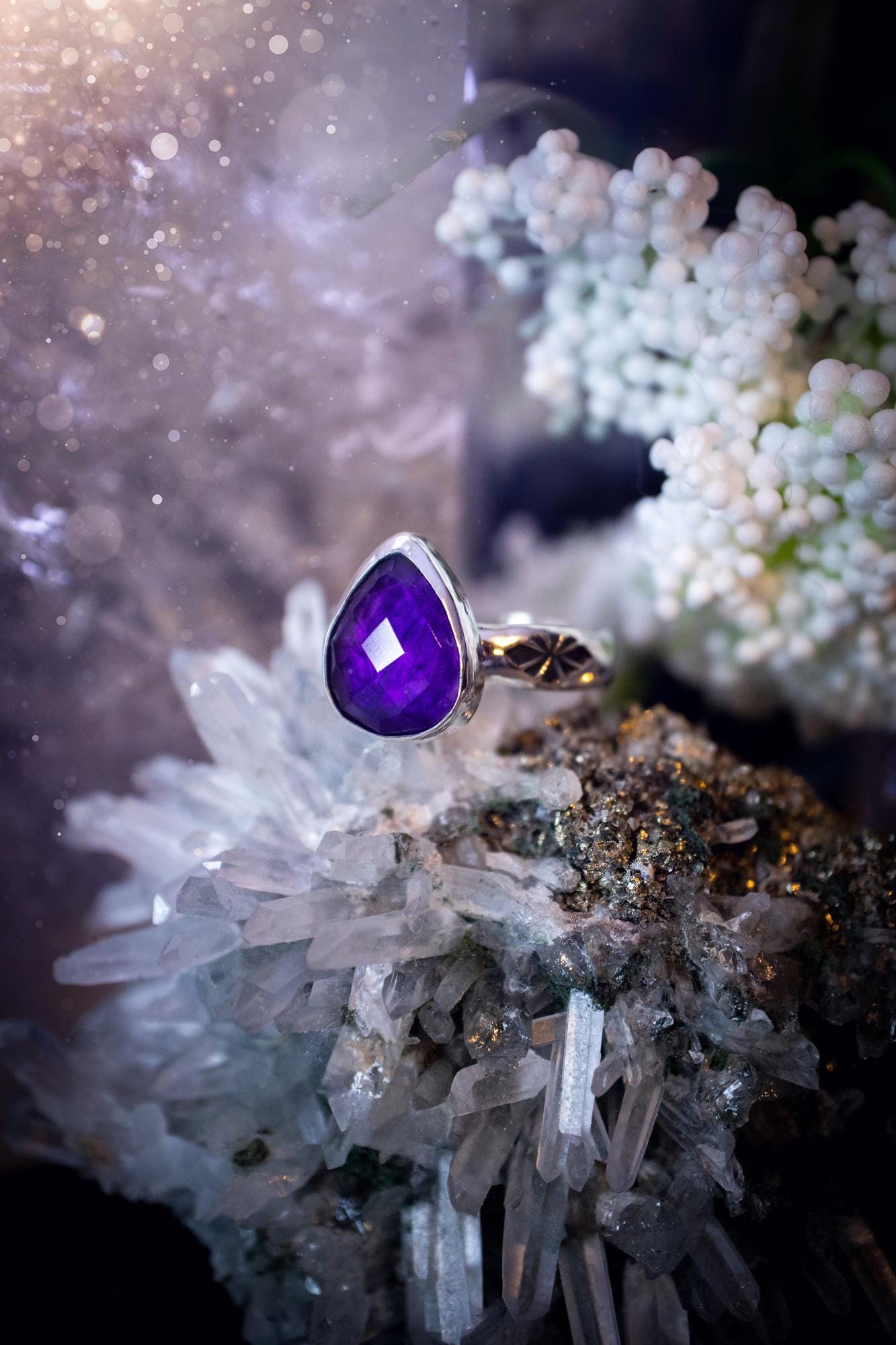 Beautiful and handcrafted, natural purple amethyst crystal, staking ring. This stunning ring has been hand made using fine and sterling silver. It features a beautiful and natural purple amethyst crystal that is rose cut with such a gorgeous colour. The ring shank on this ring has been stamped with a gothic pattern to give it a one of a kind vibe. Ideal gift for that special person in your life, or for any crystal and jewellery lover. Hippy, witchy and gothic jewellery for the soul.