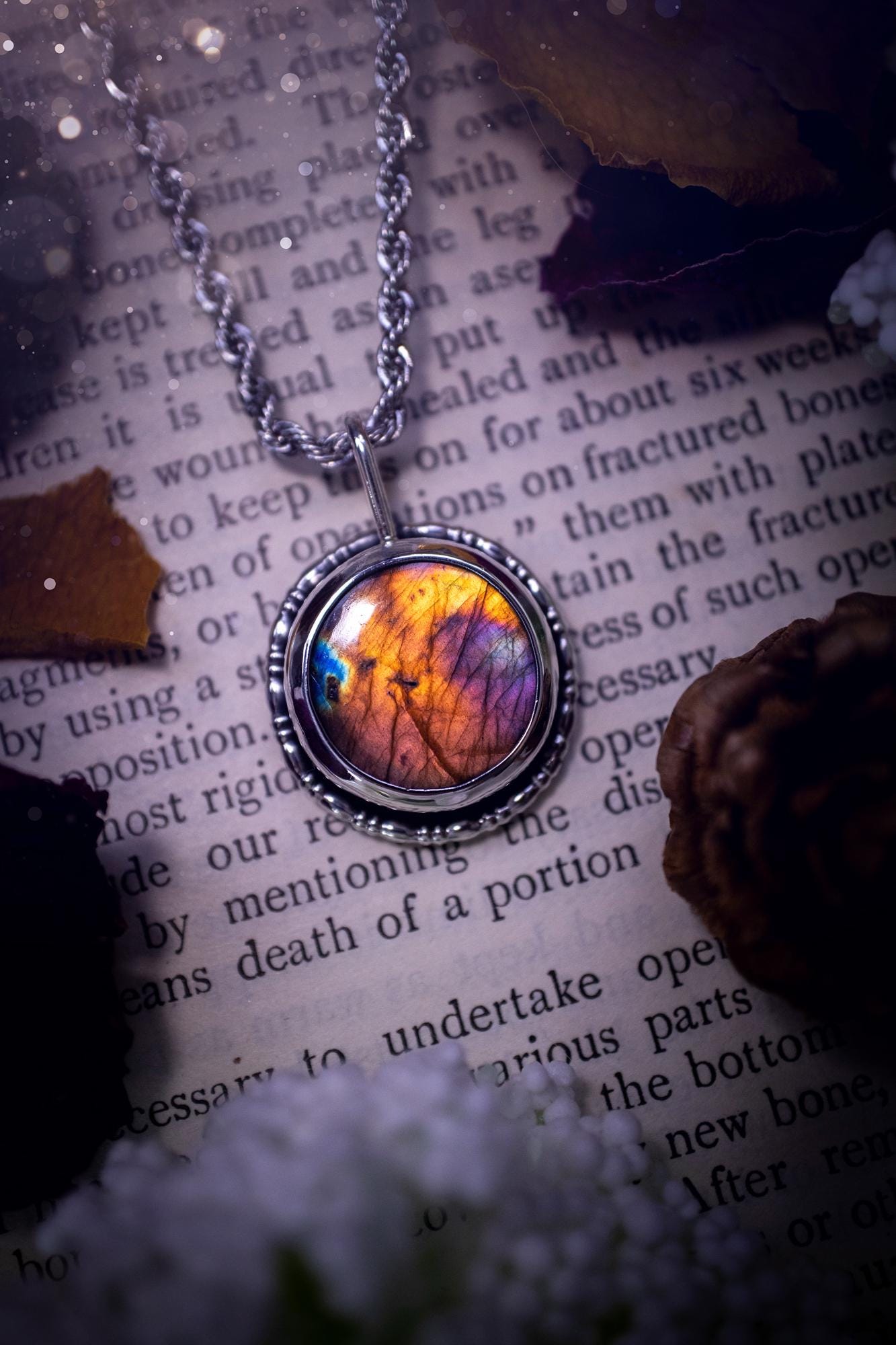 Beautiful and handcrafted, natural rainbow, pink, purple, and orange labradorite spectrolite pendant necklace. This beautiful pendant has been handmade using recycled fine and sterling silver. Featuring a round labradorite that is full of natural pinks, purples and orange hues. Around the crystal is a smooth inner bezel with gallery wire around as the outer bezel. This is the ideal piece of jewellery for a loved one or to treat yourself. Suitable for crystal and jewellery lovers. Gothic vibes.