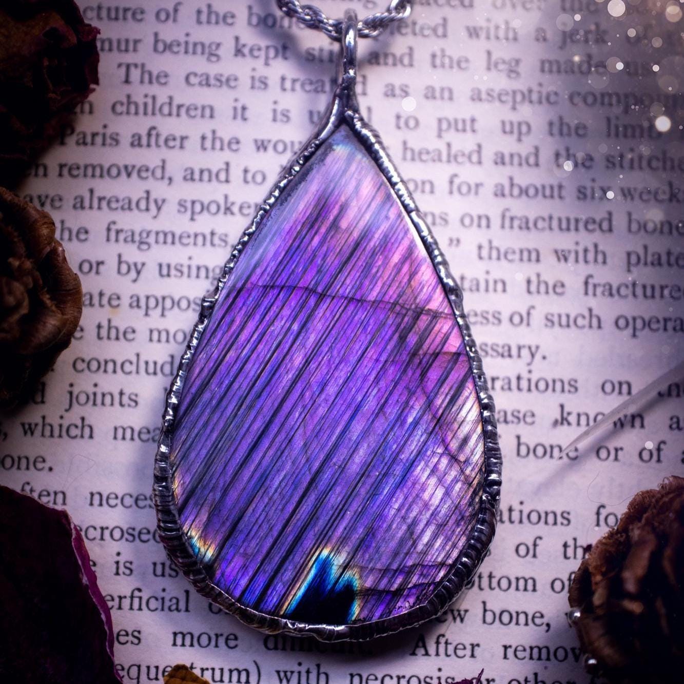 The ultimate labradorite soft soldered pendant necklace. This pendant necklace features the most beautiful and natural Labradorite spectrolite crystal that has so many hues of blue and purple, with stripes. Handmade using the tiffany technique, also known as soft soldering. This piece is made from solder which contains metals and silver and is safe to wear. The ideal gift for any jewellery lover and crystal collector! Witchy, gothic and hippy jewellery that has been made for the soul.