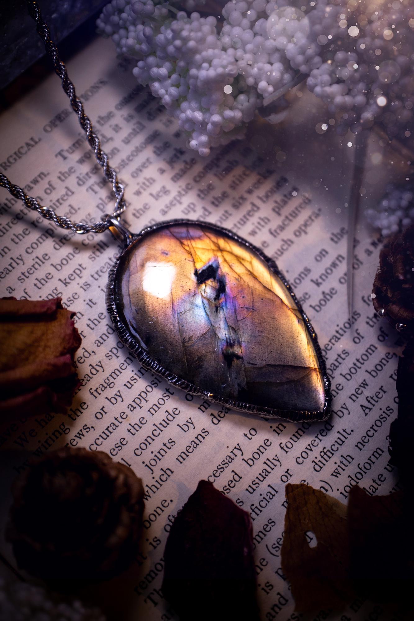 The ultimate labradorite soft soldered pendant necklace. This pendant necklace features the most beautiful, natural and very unique Labradorite spectrolite crystal that has so many hues of silver, purple, pink and orange. Handmade using the tiffany technique, also known as soft soldering. This piece is made from solder which contains silver and is safe to wear. The ideal gift for any jewellery lover and crystal collector! Witchy, gothic and hippy jewellery that has been made for the soul.