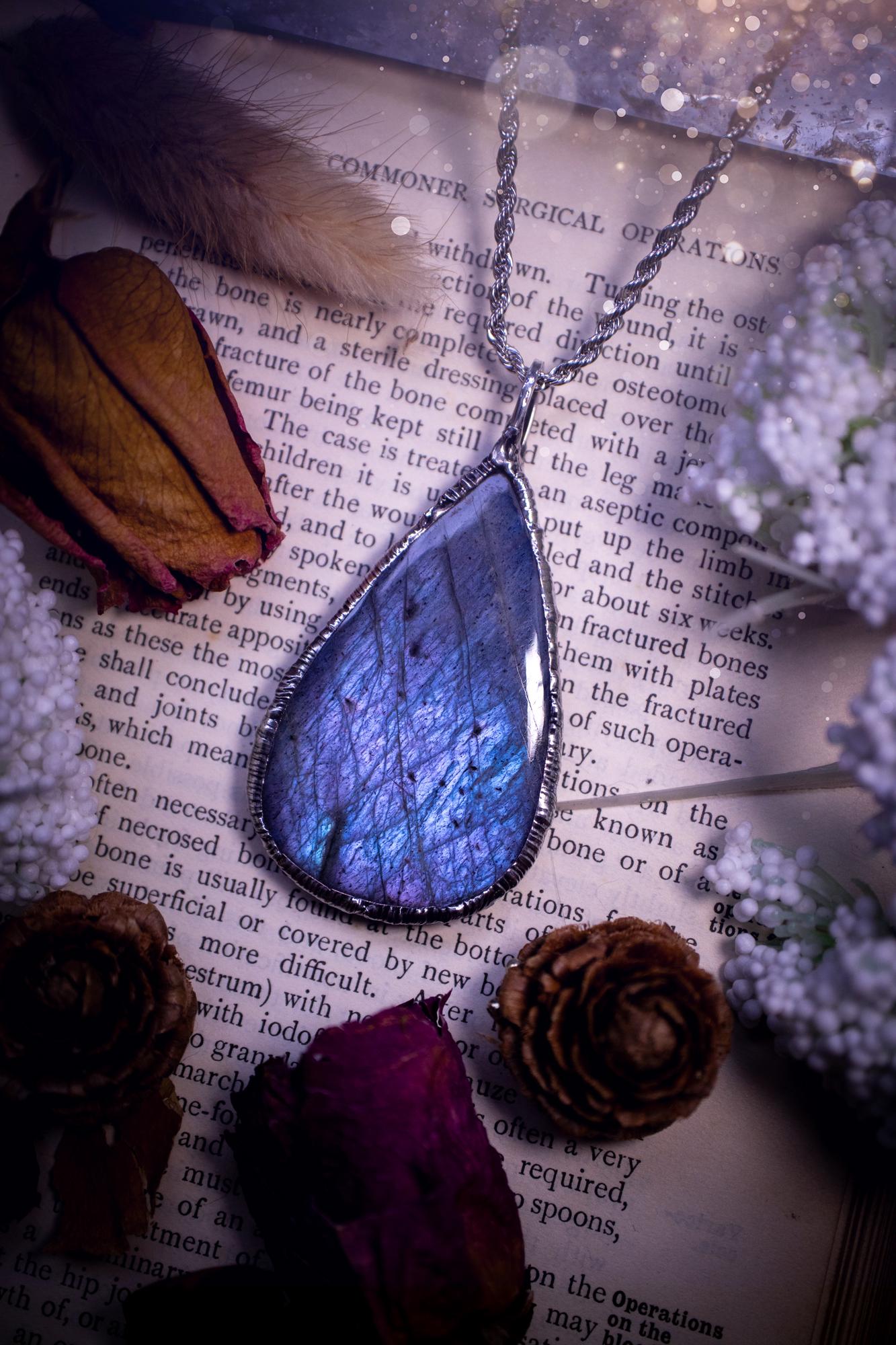 The ultimate labradorite soft soldered pendant necklace. This pendant necklace features the most beautiful and natural Labradorite spectrolite crystal that has so many hues of pastel blue and purples. Handmade using the tiffany technique, also known as soft soldering. This piece is made from solder which contains metals and silver and is safe to wear. The ideal gift for any jewellery lover and crystal collector! Witchy, gothic and hippy jewellery that has been made for the soul.