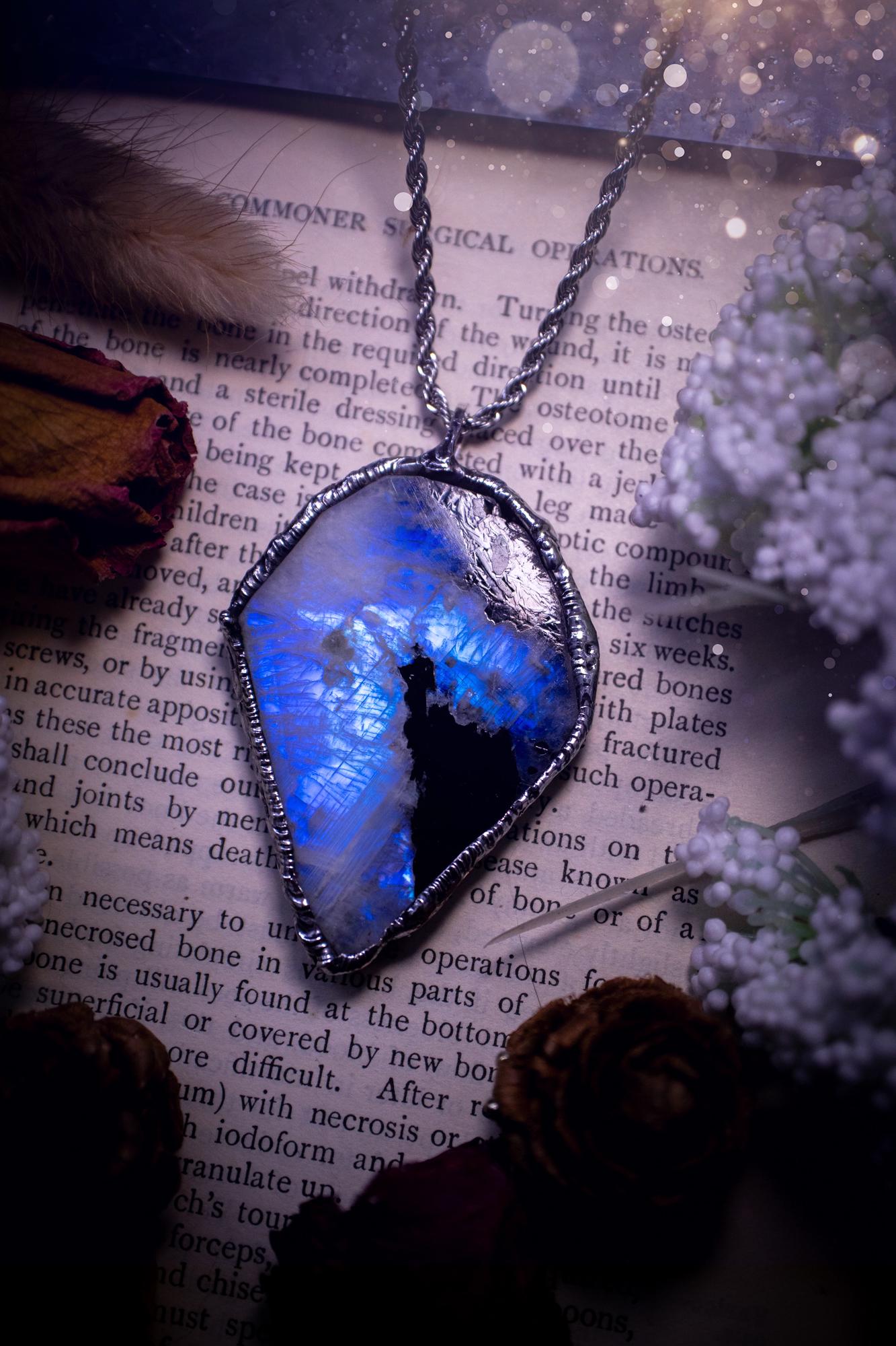 Handmade and beautiful, rainbow moonstone slab, soft soldered pendant necklace. This pendant necklace features the most gorgeous and flashy rainbow moonstone slab crystal, full of glittery shimmer and a deep lovely blue hue. Handcrafted using the soft solder method, also known as the tiffany technique, an ancient technique used to created stained glass windows. The solder used is lead free and totally safe to wear, it contains elements of silver and polishes up to a high lustre. Gothic jewellery