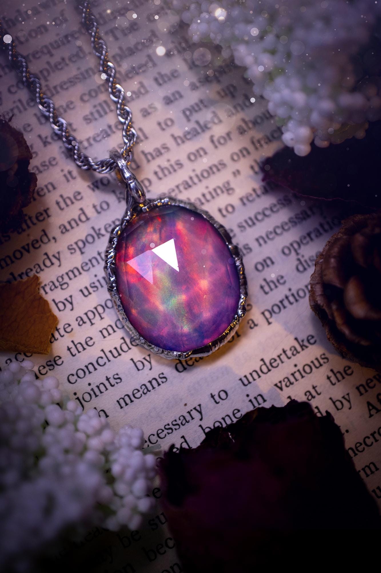 A beautiful, one of a kind, aurora opal pendant necklace. This little statement necklace is handmade using the tiffany technique, also known as soft soldering. Featuring the most stunning, and sparkly aurora opal which is full of pinks, greens and blues just like the northern lights. Aurora opals are man made opals that look similar to natural ones, they have a layer of rose quartz on top to give extra shine. The ideal gift for any crystal or jewellery lover. Gothic and witchy jewellery