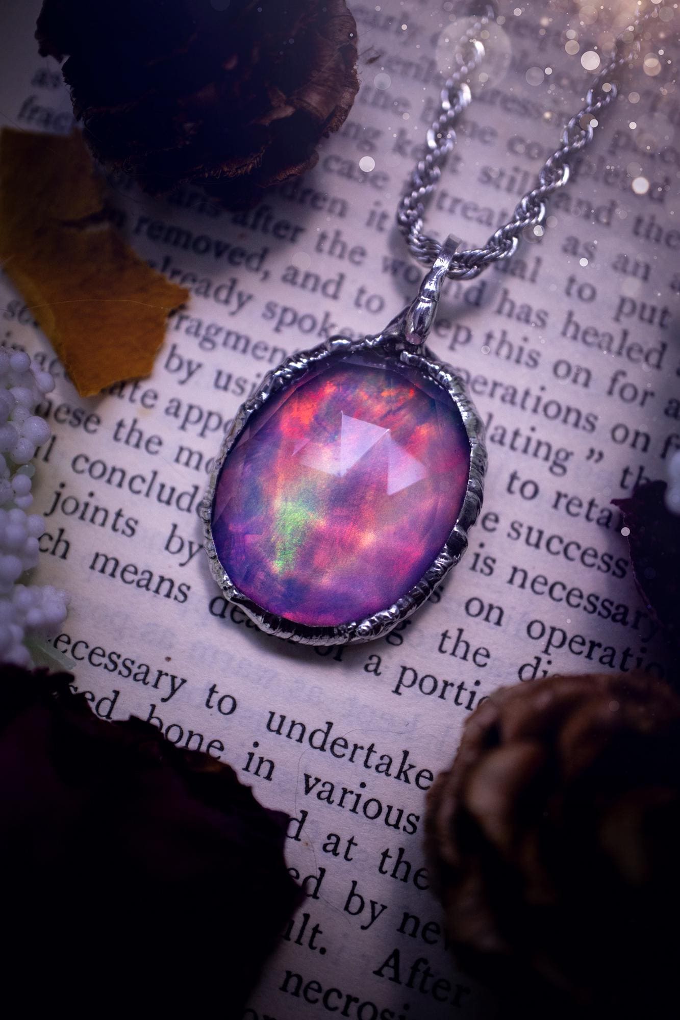 A beautiful, one of a kind, aurora opal pendant necklace. This little statement necklace is handmade using the tiffany technique, also known as soft soldering. Featuring the most stunning, and sparkly aurora opal which is full of pinks, greens and blues just like the northern lights. Aurora opals are man made opals that look similar to natural ones, they have a layer of rose quartz on top to give extra shine. The ideal gift for any crystal or jewellery lover. Gothic and witchy jewellery