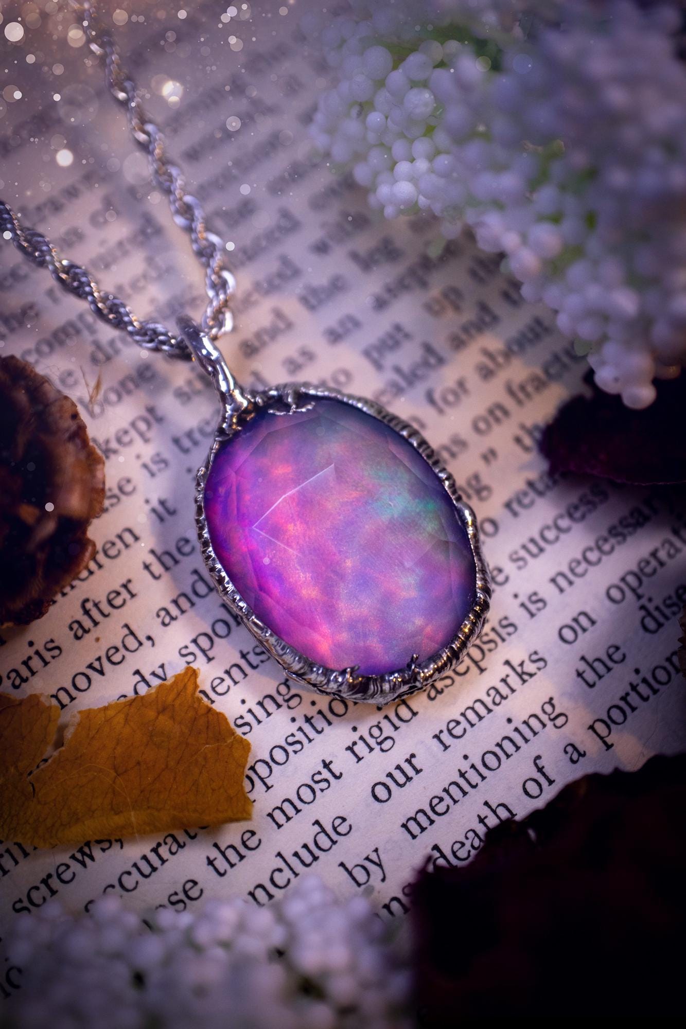 A beautiful, one of a kind, aurora opal pendant necklace. This little statement necklace is handmade using the tiffany technique, also known as soft soldering. Featuring the most stunning, and sparkly aurora opal which is full of pinks, greens and blues just like the northern lights. Aurora opals are man made opals that look similar to natural ones, they have a layer of rose quartz on top to give extra shine. The ideal gift for any crystal or jewellery lover. Gothic and witchy jewellery