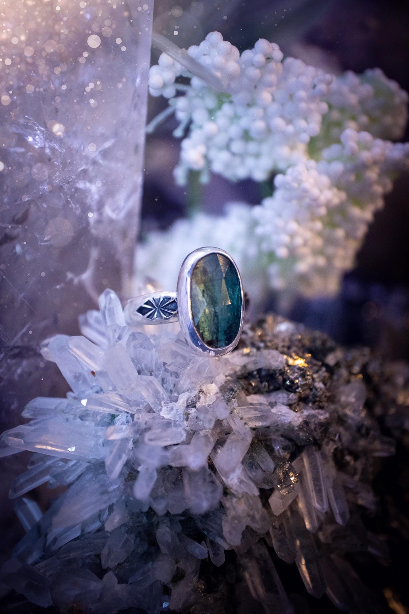 Beautiful and handcrafted, natural teal green kyanite crystal, staking ring. This stunning ring has been hand made using fine and sterling silver. It features a beautiful and natural teal green kyanite crystal that has rainbows and flash, such a gorgeous colour. The ring shank on this ring has been stamped with a gothic pattern to give it a one of a kind vibe. Ideal gift for that special person in your life, or for any crystal and jewellery lover. Hippy, witchy and gothic jewellery for the soul.