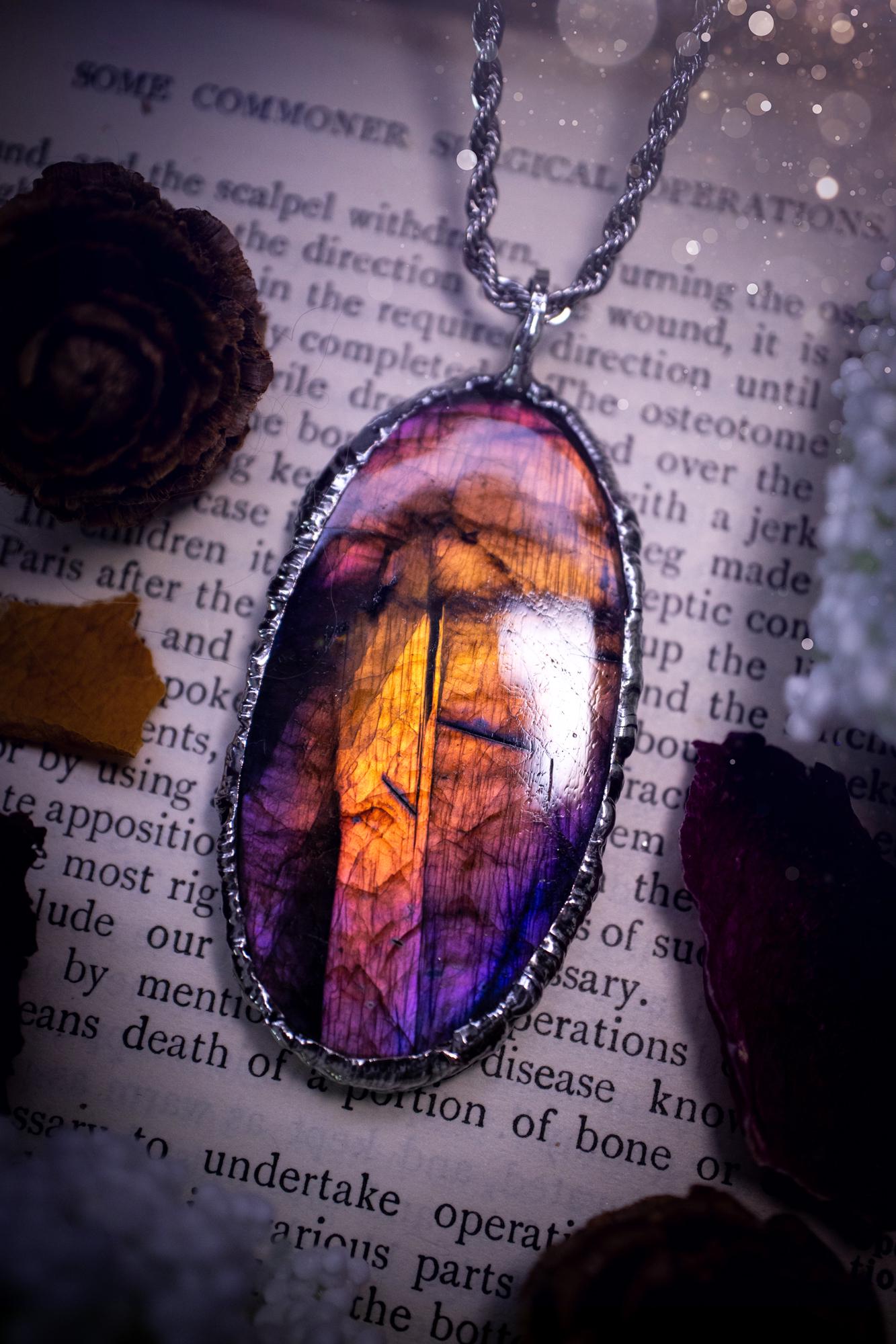 The ultimate labradorite soft soldered pendant necklace. This pendant necklace features the most beautiful and natural Labradorite spectrolite crystal that has so many hues of purple, pink and orange. Handmade using the tiffany technique, also known as soft soldering. This piece is made from solder which contains metals and silver and is safe to wear. The ideal gift for any jewellery lover and crystal collector! Witchy, gothic and hippy jewellery that has been made for the soul.