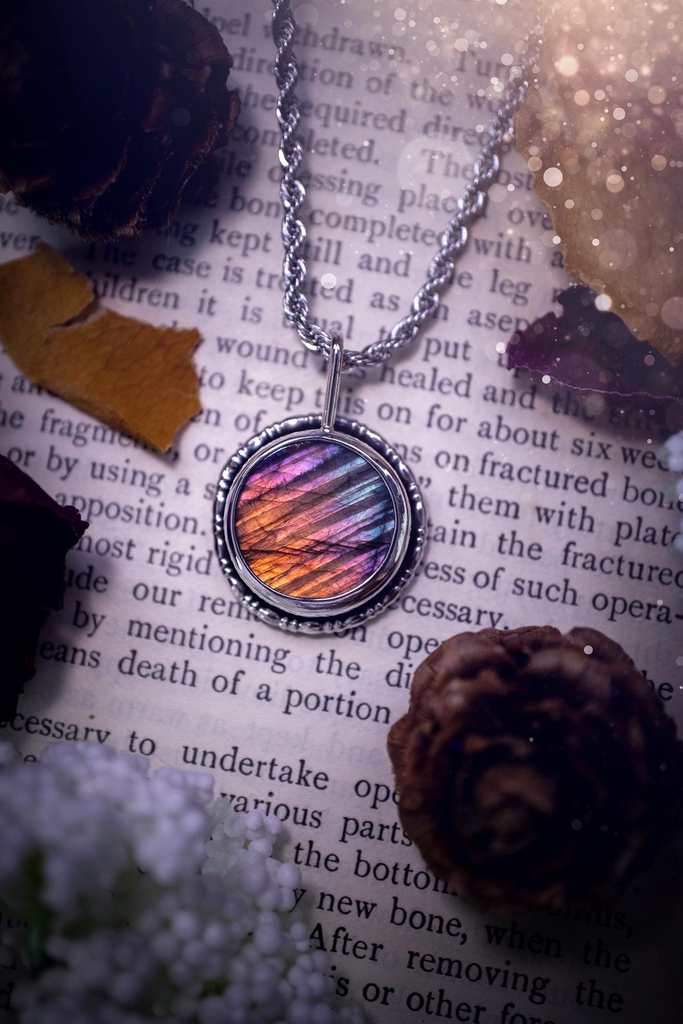 Beautiful and handcrafted, natural rainbow, pink, purple, and silver labradorite spectrolite pendant necklace. This beautiful pendant has been handmade using recycled fine and sterling silver. Featuring a round labradorite that is full of natural pinks, purples and silver hues. Around the crystal is a smooth inner bezel with gallery wire around as the outer bezel. This is the ideal piece of jewellery for a loved one or to treat yourself. Suitable for crystal and jewellery lovers. Gothic vibes.