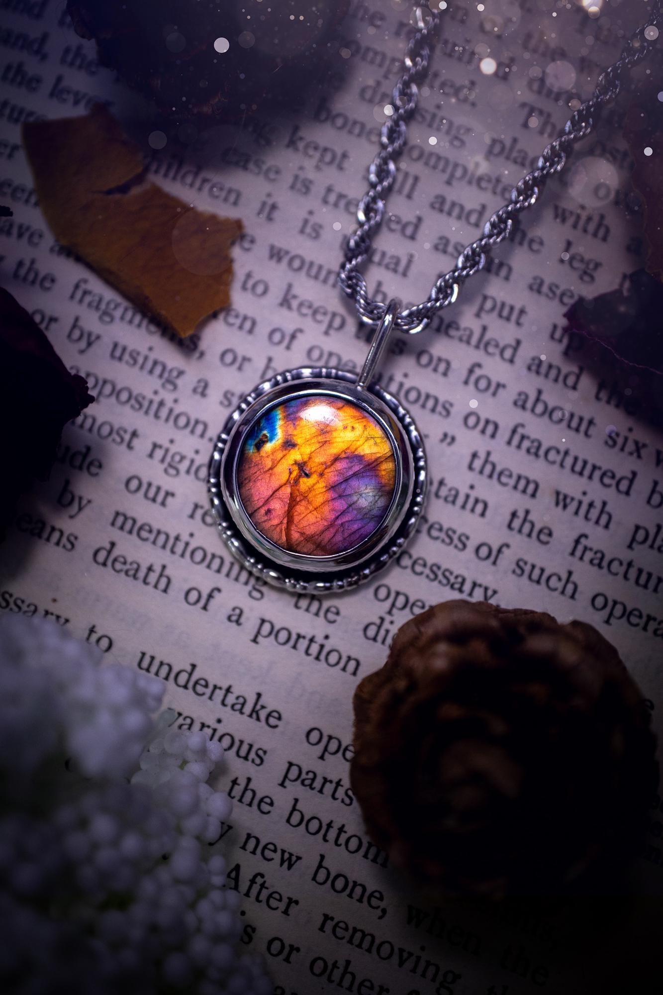 Beautiful and handcrafted, natural rainbow, pink, purple, and orange labradorite spectrolite pendant necklace. This beautiful pendant has been handmade using recycled fine and sterling silver. Featuring a round labradorite that is full of natural pinks, purples and orange hues. Around the crystal is a smooth inner bezel with gallery wire around as the outer bezel. This is the ideal piece of jewellery for a loved one or to treat yourself. Suitable for crystal and jewellery lovers. Gothic vibes.