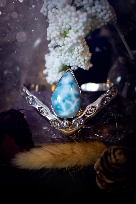 Beautifully handmade, statement larimar crystal, sterling silver cuff bracelet. This bracelet features the most stunning, high grade larimar crystal gemstone at the focal point of this wishbone cuff. Made from a mix of fine and sterling silver with stamped detail, and ball component to give the bracelet its uniqueness! A beautiful piece of jewellery that is ideal for any crystal or jewellery lover! The piece is full of hippy and beach vibes and would look lovely with any summer outfit!