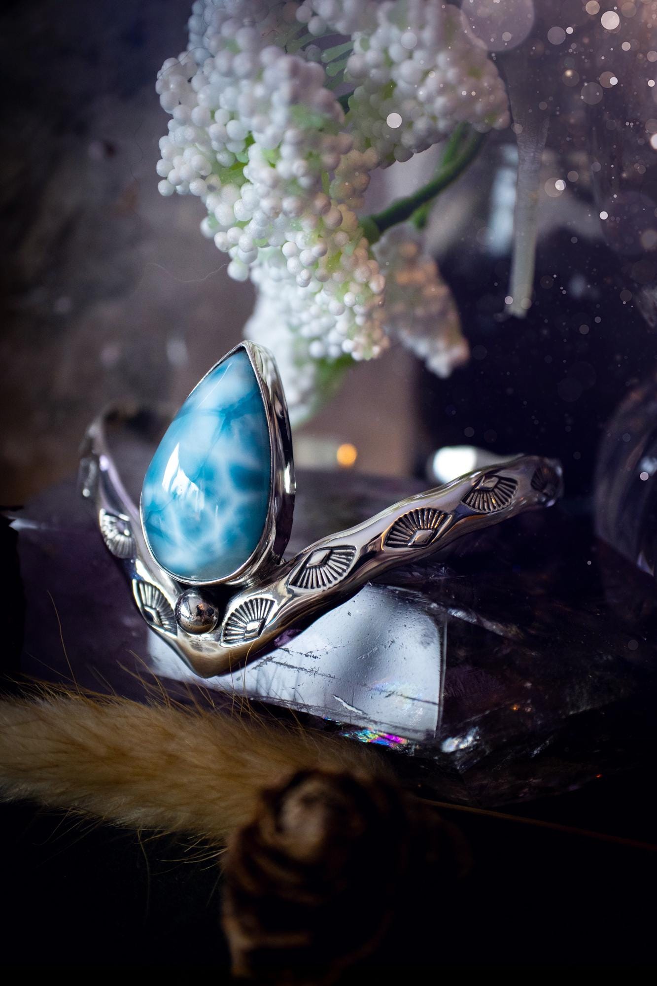 Beautifully handmade, statement larimar crystal, sterling silver cuff bracelet. This bracelet features the most stunning, high grade larimar crystal gemstone at the focal point of this wishbone cuff. Made from a mix of fine and sterling silver with stamped detail, and ball component to give the bracelet its uniqueness! A beautiful piece of jewellery that is ideal for any crystal or jewellery lover! The piece is full of hippy and beach vibes and would look lovely with any summer outfit!