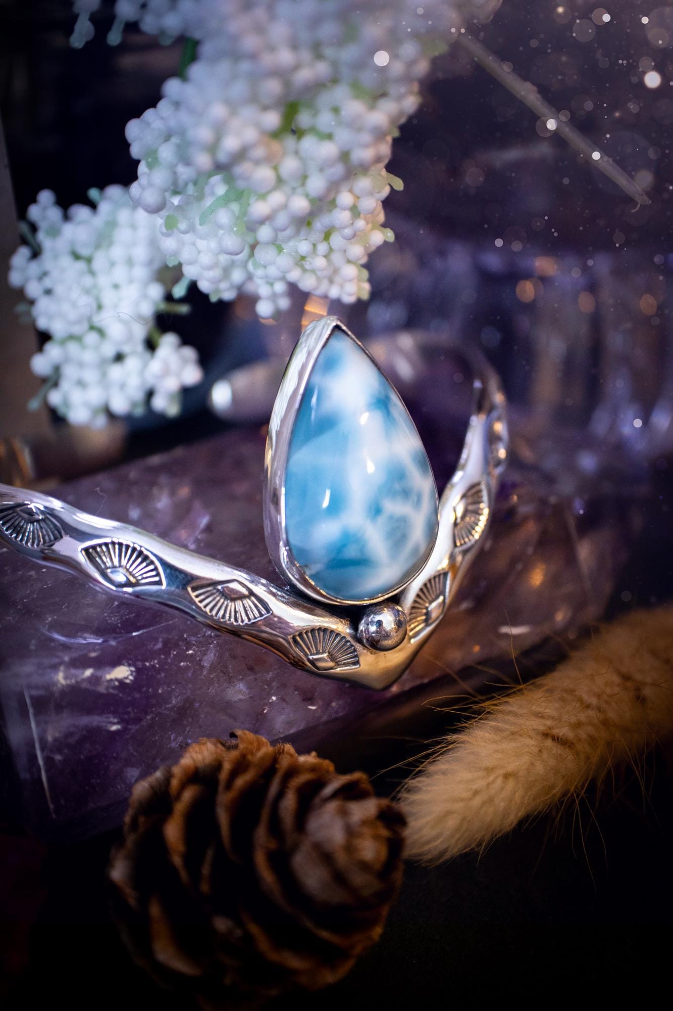 Beautifully handmade, statement larimar crystal, sterling silver cuff bracelet. This bracelet features the most stunning, high grade larimar crystal gemstone at the focal point of this wishbone cuff. Made from a mix of fine and sterling silver with stamped detail, and ball component to give the bracelet its uniqueness! A beautiful piece of jewellery that is ideal for any crystal or jewellery lover! The piece is full of hippy and beach vibes and would look lovely with any summer outfit!