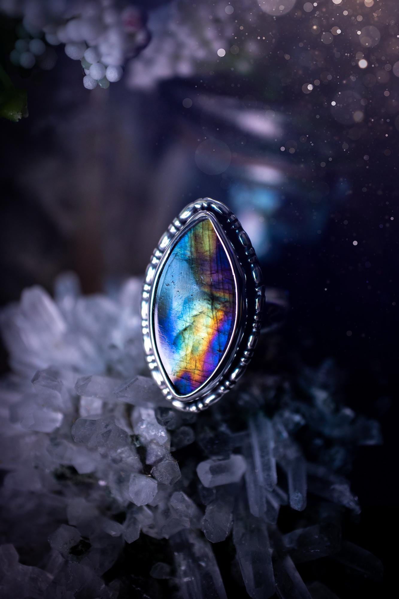 Handcrafted sterling silver statement ring featuring a stunning spectrolite labradorite crystal with vibrant flashes of purple, yellow, and blue. This magical gemstone shimmers with an ethereal glow, making it a captivating piece for any jewellery collection. Ideal for crystal lovers, spiritual souls, and those drawn to unique, one-of-a-kind designs. A bold, mystical accessory perfect for expressing your inner light and energy. Gothic and handmade jewellery gifts, ideal for crystal lovers.
