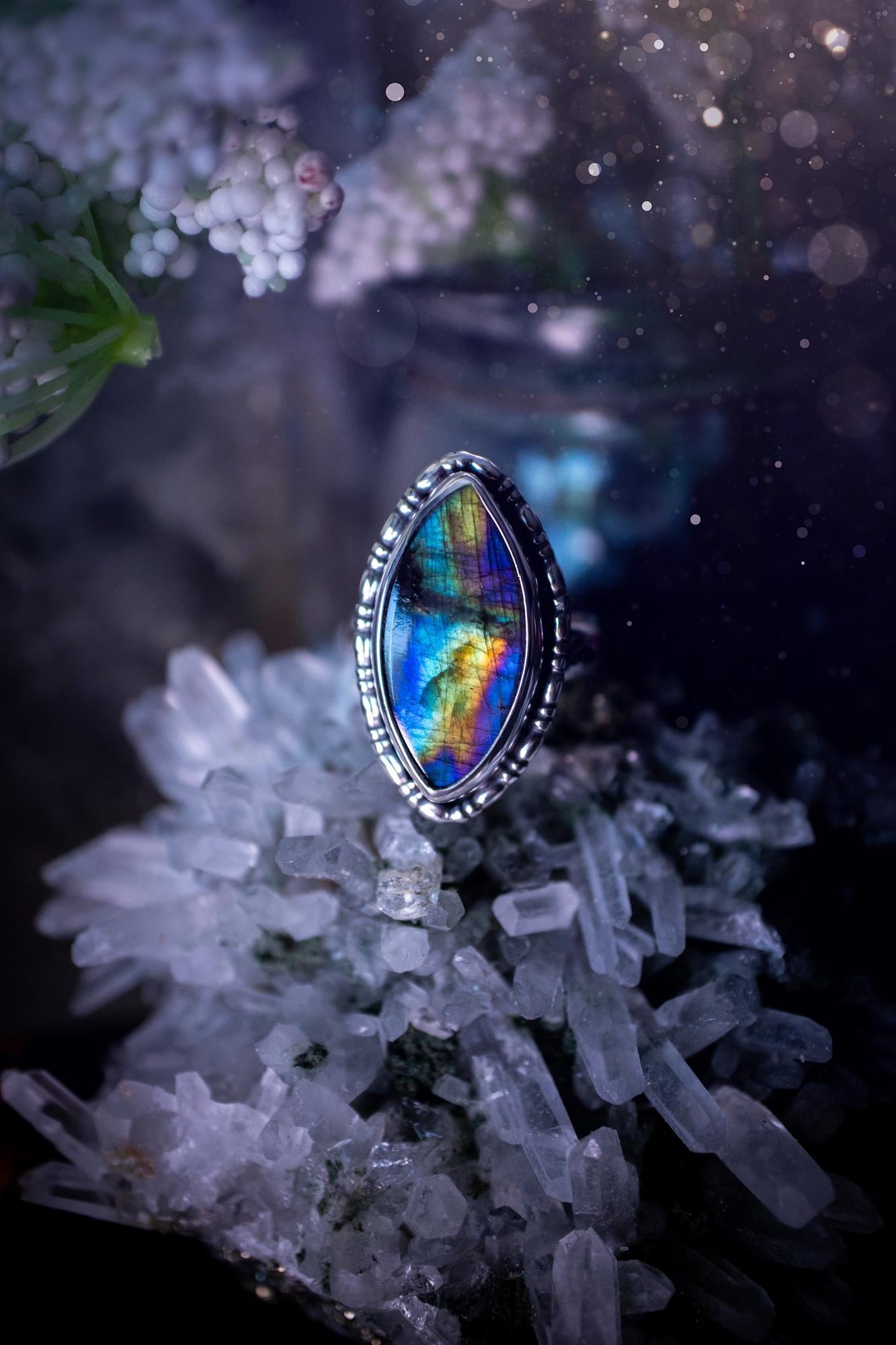 Handcrafted sterling silver statement ring featuring a stunning spectrolite labradorite crystal with vibrant flashes of purple, yellow, and blue. This magical gemstone shimmers with an ethereal glow, making it a captivating piece for any jewellery collection. Ideal for crystal lovers, spiritual souls, and those drawn to unique, one-of-a-kind designs. A bold, mystical accessory perfect for expressing your inner light and energy. Gothic and handmade jewellery gifts, ideal for crystal lovers.