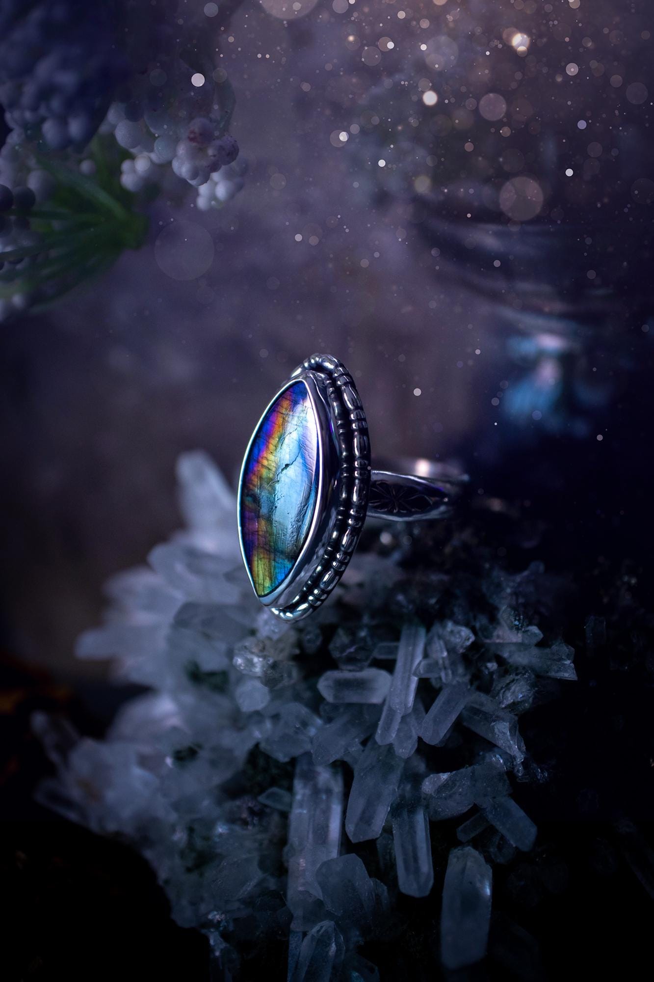 Handcrafted sterling silver statement ring featuring a stunning spectrolite labradorite crystal with vibrant flashes of purple, yellow, and blue. This magical gemstone shimmers with an ethereal glow, making it a captivating piece for any jewellery collection. Ideal for crystal lovers, spiritual souls, and those drawn to unique, one-of-a-kind designs. A bold, mystical accessory perfect for expressing your inner light and energy. Gothic and handmade jewellery gifts, ideal for crystal lovers.