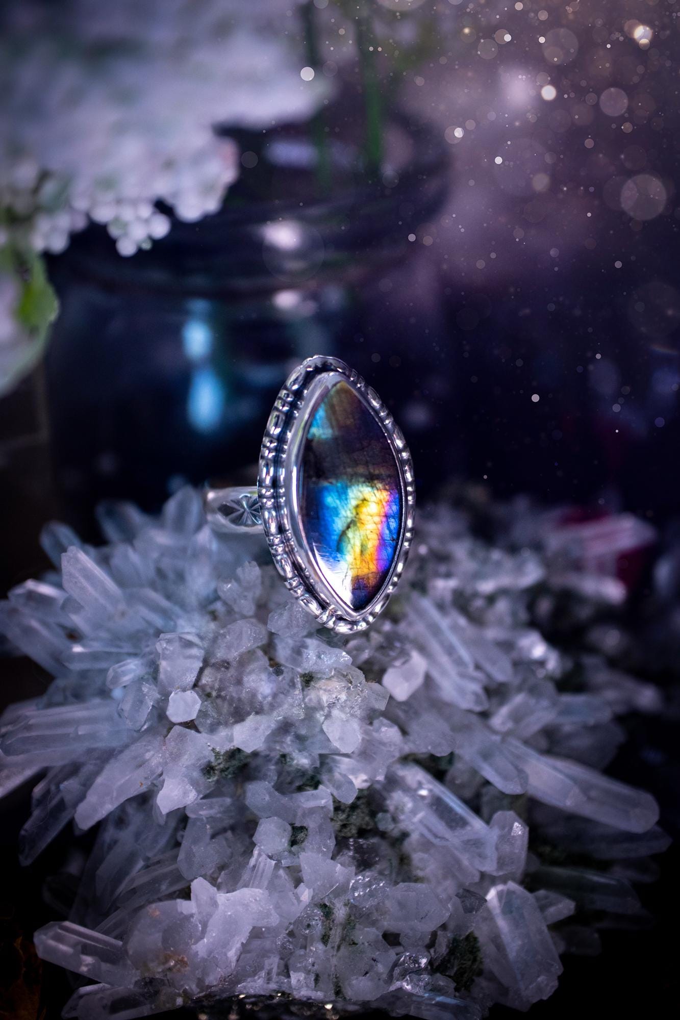 Handcrafted sterling silver statement ring featuring a stunning spectrolite labradorite crystal with vibrant flashes of purple, yellow, and blue. This magical gemstone shimmers with an ethereal glow, making it a captivating piece for any jewellery collection. Ideal for crystal lovers, spiritual souls, and those drawn to unique, one-of-a-kind designs. A bold, mystical accessory perfect for expressing your inner light and energy. Gothic and handmade jewellery gifts, ideal for crystal lovers.