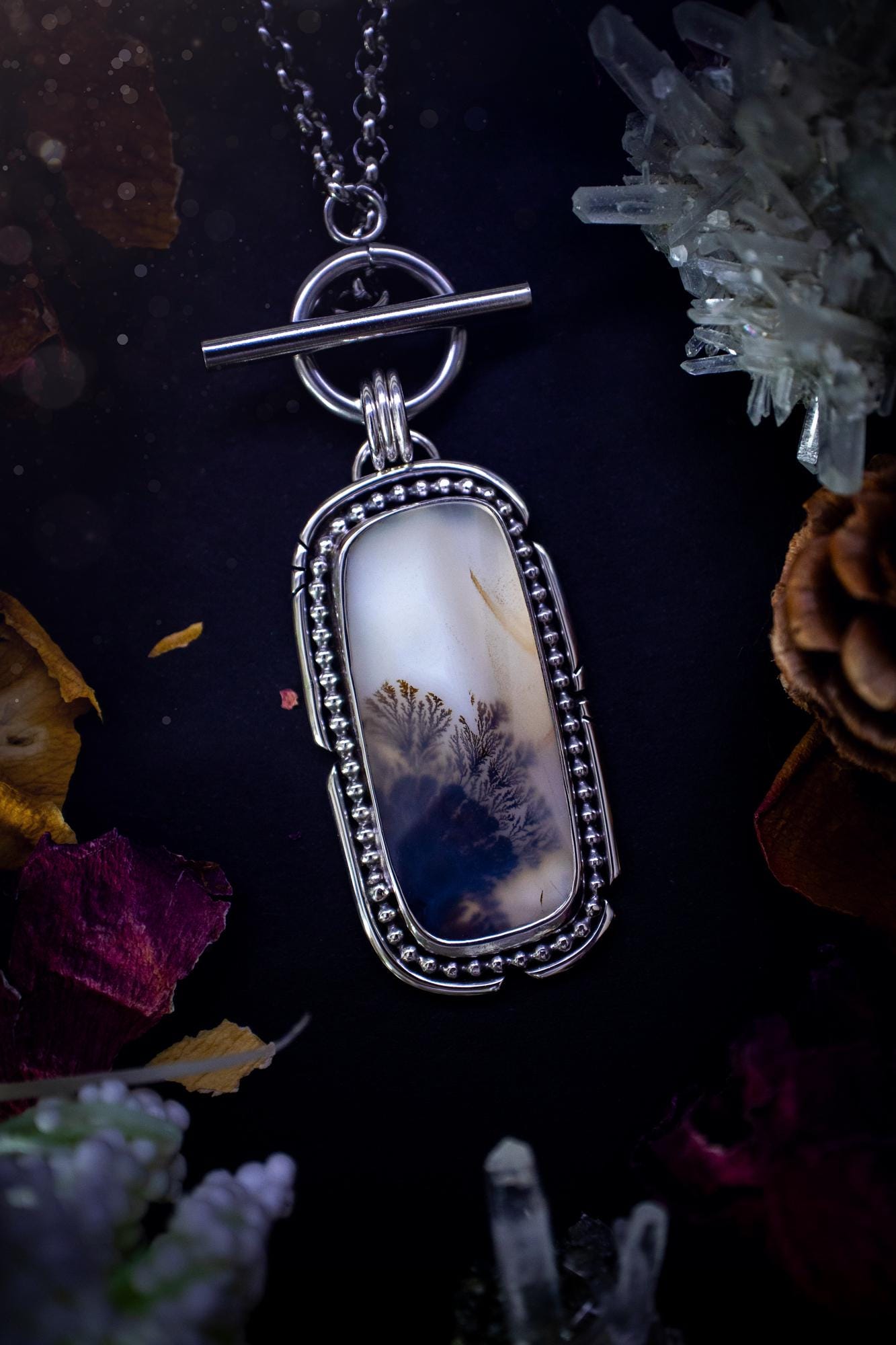 Stunning, bespoke and natural, scenic dendritic agate, sterling silver statement pendant necklace. This pendant necklace has been handmade using fine and sterling silver. It features a beautiful scenic dendritic agate that has a beautiful pattern that looks similar to little trees, a very unique and one of a kind jewellery piece. Around the crystal is a smooth bezel with smooth and beaded wire. A lovely gift for any crystal and jewellery lover. This piece has a witchy and gothic vibes, hippy.