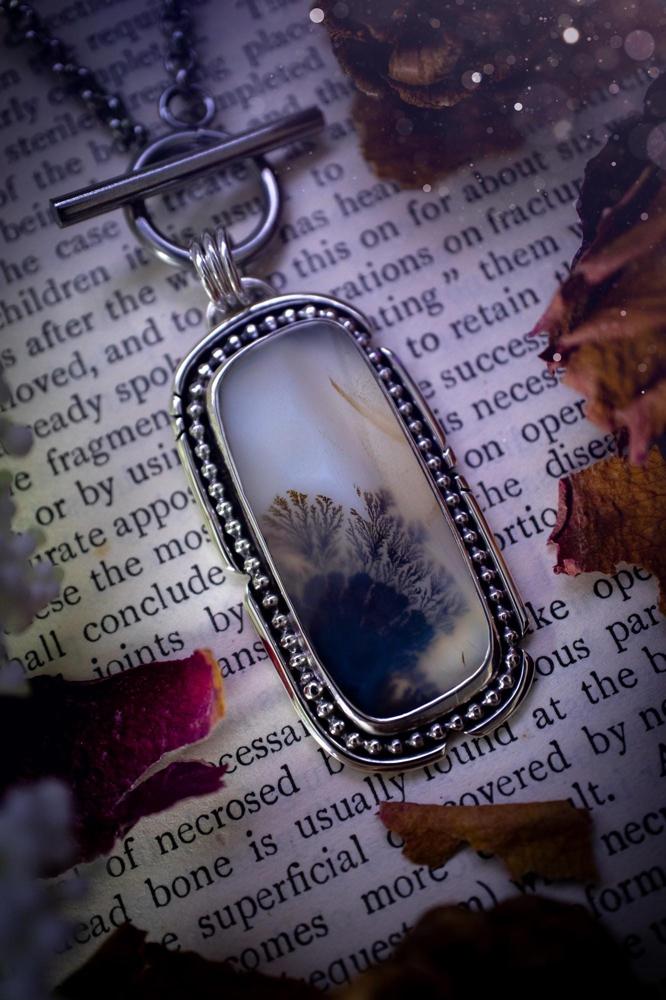 Stunning, bespoke and natural, scenic dendritic agate, sterling silver statement pendant necklace. This pendant necklace has been handmade using fine and sterling silver. It features a beautiful scenic dendritic agate that has a beautiful pattern that looks similar to little trees, a very unique and one of a kind jewellery piece. Around the crystal is a smooth bezel with smooth and beaded wire. A lovely gift for any crystal and jewellery lover. This piece has a witchy and gothic vibes, hippy.