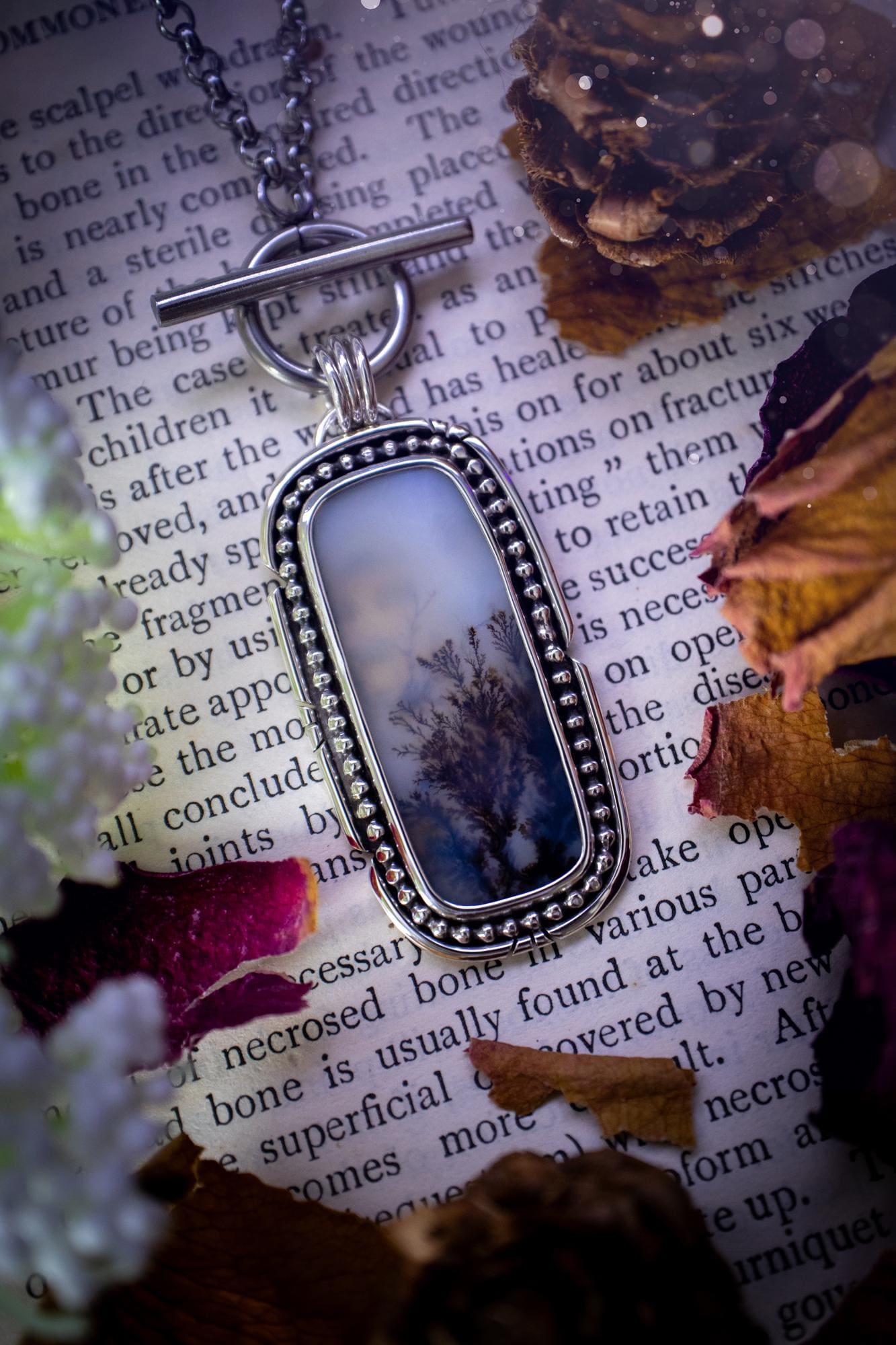 Stunning, bespoke and natural, scenic dendritic agate, sterling silver statement pendant necklace. This pendant necklace has been handmade using fine and sterling silver. It features a beautiful scenic dendritic agate that has a beautiful pattern that looks similar to little trees, a very unique and one of a kind jewellery piece. Around the crystal is a smooth bezel with smooth and beaded wire. A lovely gift for any crystal and jewellery lover. This piece has a witchy and gothic vibes, hippy.