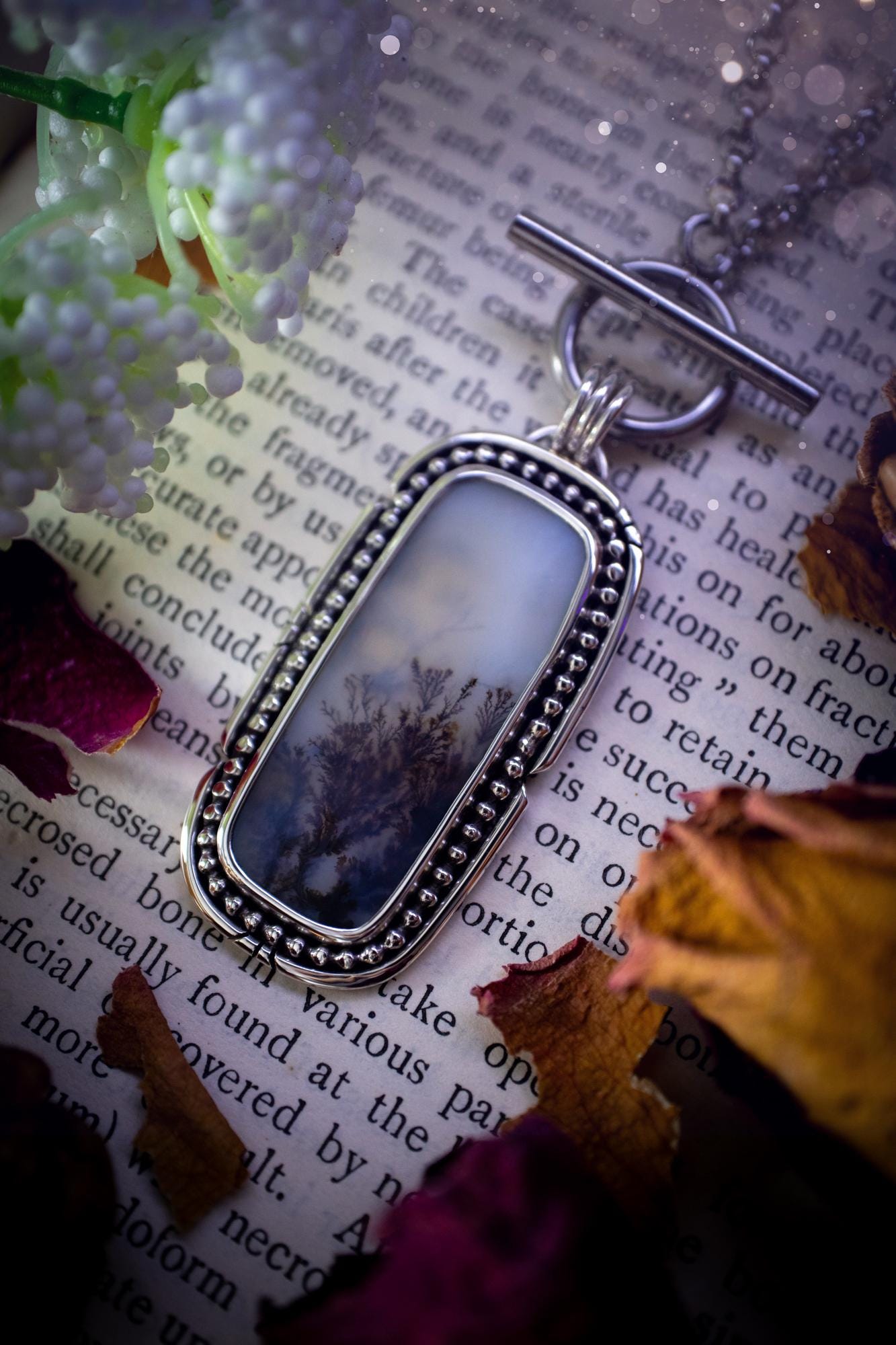 Stunning, bespoke and natural, scenic dendritic agate, sterling silver statement pendant necklace. This pendant necklace has been handmade using fine and sterling silver. It features a beautiful scenic dendritic agate that has a beautiful pattern that looks similar to little trees, a very unique and one of a kind jewellery piece. Around the crystal is a smooth bezel with smooth and beaded wire. A lovely gift for any crystal and jewellery lover. This piece has a witchy and gothic vibes, hippy.
