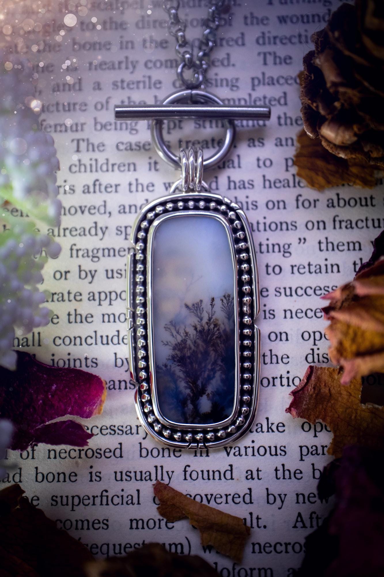 Stunning, bespoke and natural, scenic dendritic agate, sterling silver statement pendant necklace. This pendant necklace has been handmade using fine and sterling silver. It features a beautiful scenic dendritic agate that has a beautiful pattern that looks similar to little trees, a very unique and one of a kind jewellery piece. Around the crystal is a smooth bezel with smooth and beaded wire. A lovely gift for any crystal and jewellery lover. This piece has a witchy and gothic vibes, hippy.