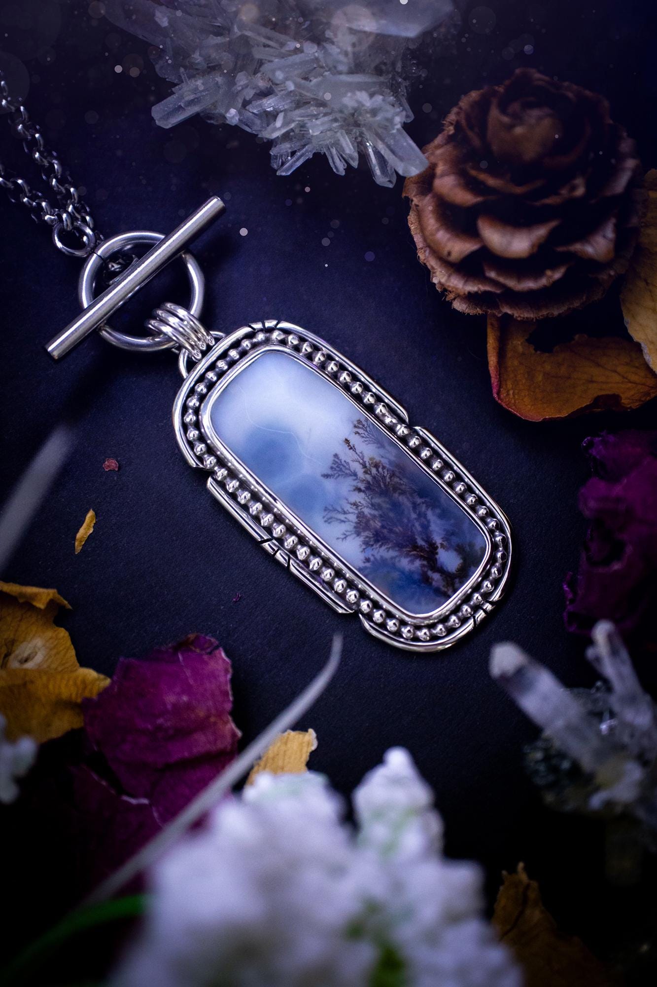 Stunning, bespoke and natural, scenic dendritic agate, sterling silver statement pendant necklace. This pendant necklace has been handmade using fine and sterling silver. It features a beautiful scenic dendritic agate that has a beautiful pattern that looks similar to little trees, a very unique and one of a kind jewellery piece. Around the crystal is a smooth bezel with smooth and beaded wire. A lovely gift for any crystal and jewellery lover. This piece has a witchy and gothic vibes, hippy.