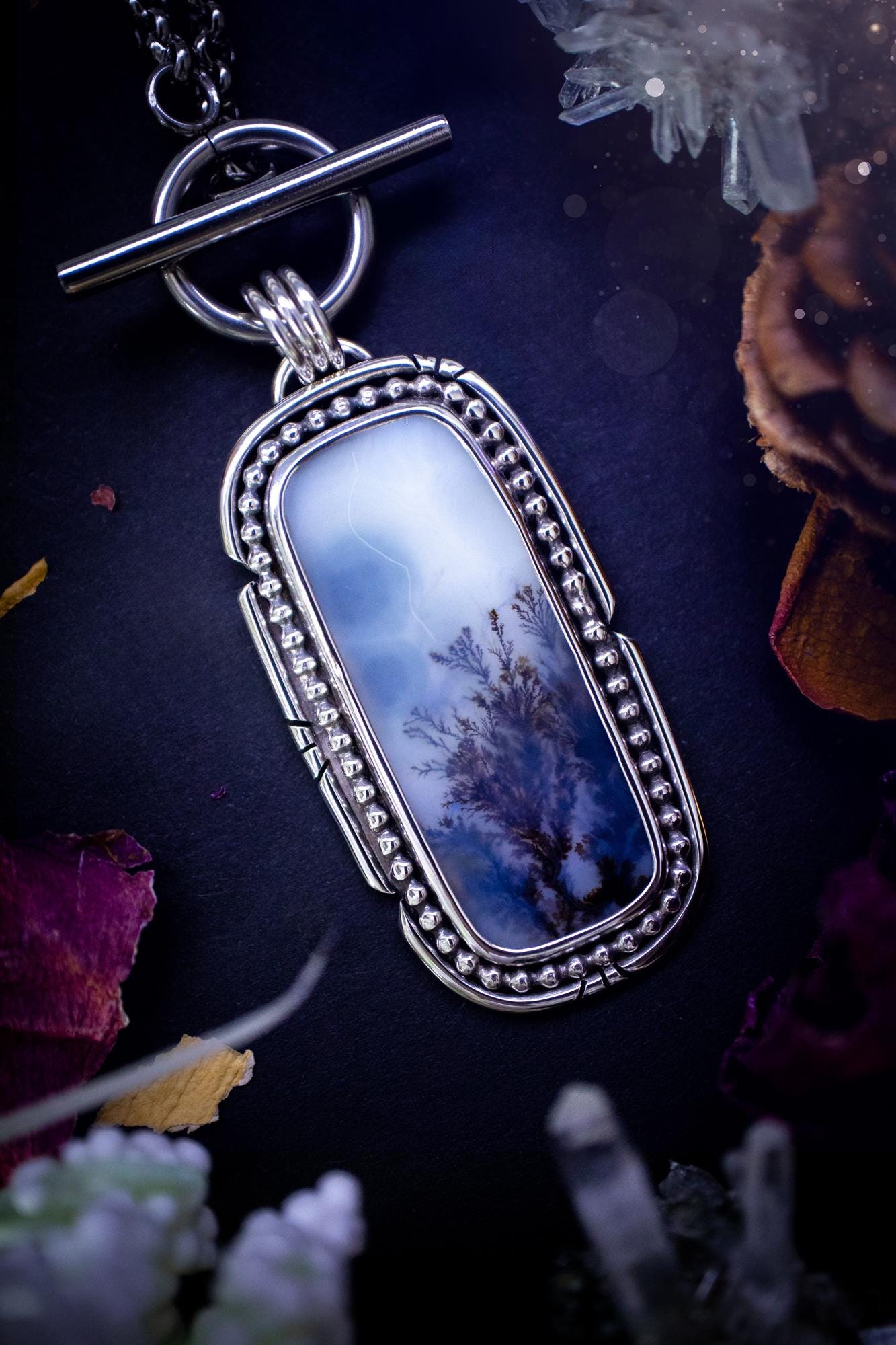 Stunning, bespoke and natural, scenic dendritic agate, sterling silver statement pendant necklace. This pendant necklace has been handmade using fine and sterling silver. It features a beautiful scenic dendritic agate that has a beautiful pattern that looks similar to little trees, a very unique and one of a kind jewellery piece. Around the crystal is a smooth bezel with smooth and beaded wire. A lovely gift for any crystal and jewellery lover. This piece has a witchy and gothic vibes, hippy.