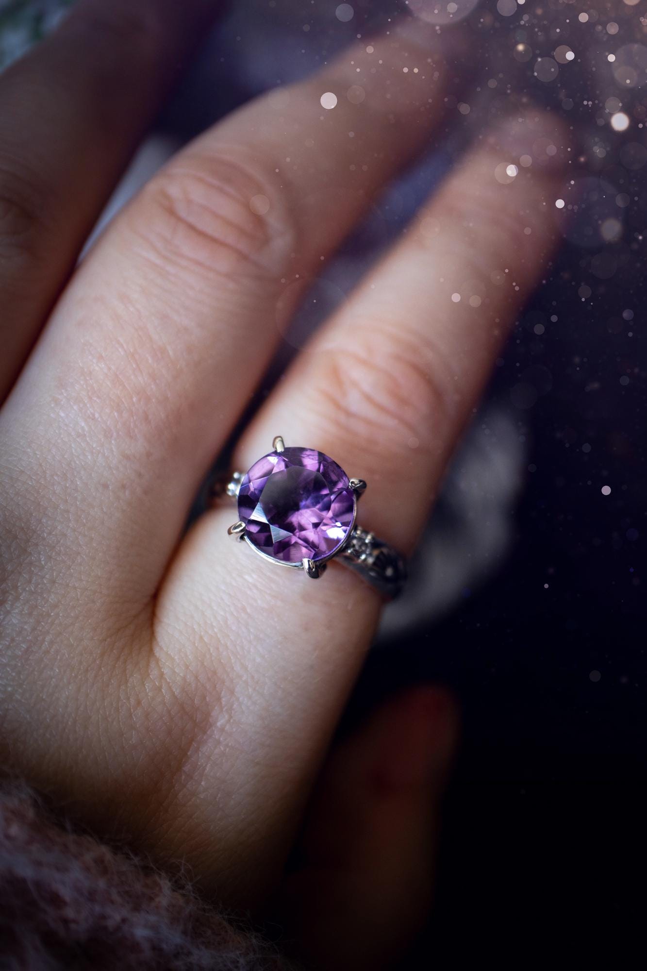 Beautifully handmade, and bespoke, natural amethyst crystal statement ring. This one of a kind ring has been handmade using a mix of fine and sterling silver. Featuring a beautiful, sparkly, round, natural amethyst crystal that has stunning hues of purple, along with cubic zirconia to the sides of the crystal. The ring band is stamped with unique detailing. The ideal treat and gift for anyone who is a lover of crystals and jewellery. This ring is full of gothic and witchy vibes! engagement ring