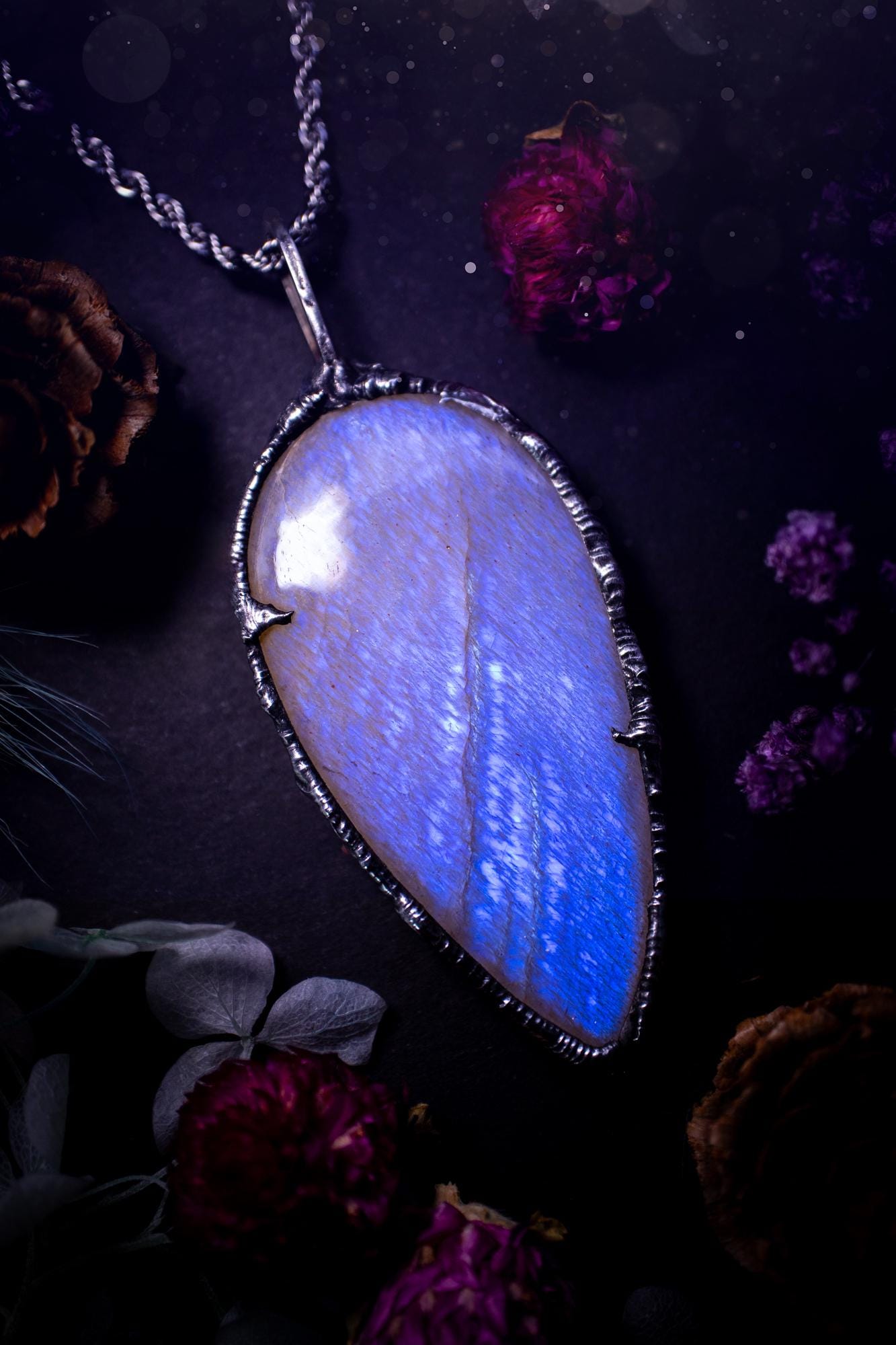 Handmade and beautiful, flashy belomorite, soft soldered pendant necklace. This pendant necklace features the most gorgeous and flashy belomorite moonstone crystal, full of glittery shimmer and a deep lovely blue hue. Handcrafted using the soft solder method, also known as the tiffany technique, an ancient technique used to created stained glass windows. The solder used is lead free and totally safe to wear, it contains elements of silver and polishes up to a high lustre. Gothic witchy jewellery