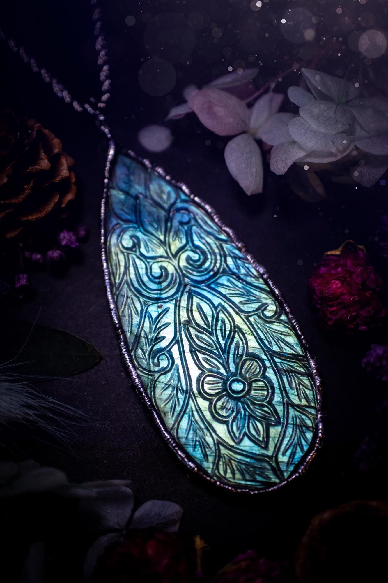Beautifully handmade and bespoke, carved labradorite, soft soldered pendant necklace. This large labradorite pendant has been crafted using the soft solder method, also known as the tiffany technique. The crystal has a bezel of lead free soft solder which contains small parts of silver that allows for oxidisation and a high lustre polish. This labradorite is full of beautiful blues and greens and has been hand carved with a beautiful floral and leaf pattern. One off, gothic and witchy jewellery