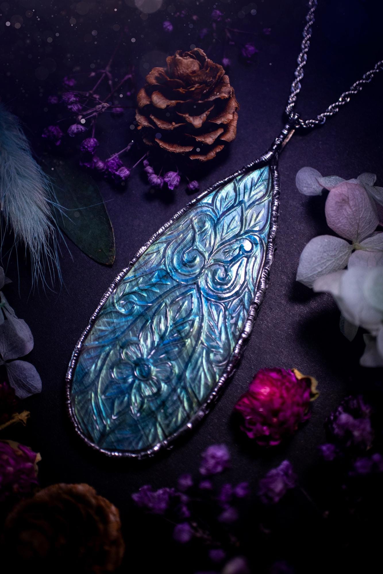Beautifully handmade and bespoke, carved labradorite, soft soldered pendant necklace. This large labradorite pendant has been crafted using the soft solder method, also known as the tiffany technique. The crystal has a bezel of lead free soft solder which contains small parts of silver that allows for oxidisation and a high lustre polish. This labradorite is full of beautiful blues and greens and has been hand carved with a beautiful floral and leaf pattern. One off, gothic and witchy jewellery