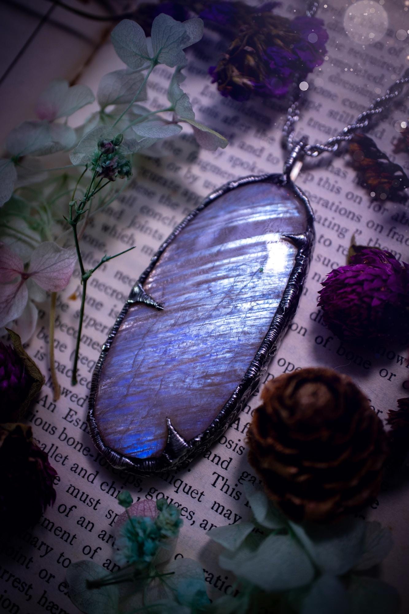 Handmade and beautiful, flashy belomorite, soft soldered pendant necklace. This pendant necklace features the most gorgeous and flashy belomorite moonstone crystal, full of glittery shimmer and a deep lovely blue hue. Handcrafted using the soft solder method, also known as the tiffany technique, an ancient technique used to created stained glass windows. The solder used is lead free and totally safe to wear, it contains elements of silver and polishes up to a high lustre. Gothic witchy jewellery