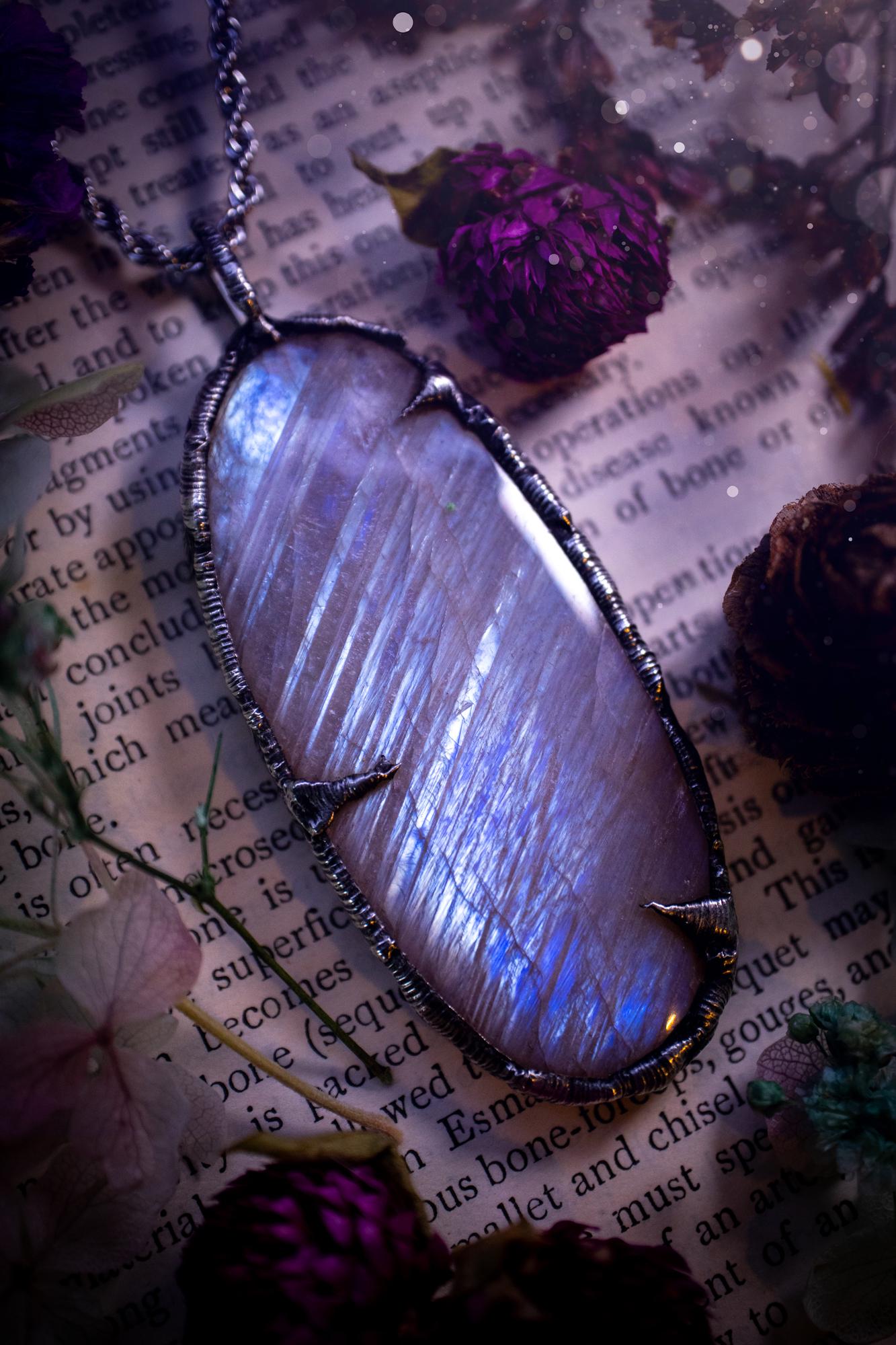 Handmade and beautiful, flashy belomorite, soft soldered pendant necklace. This pendant necklace features the most gorgeous and flashy belomorite moonstone crystal, full of glittery shimmer and a deep lovely blue hue. Handcrafted using the soft solder method, also known as the tiffany technique, an ancient technique used to created stained glass windows. The solder used is lead free and totally safe to wear, it contains elements of silver and polishes up to a high lustre. Gothic witchy jewellery