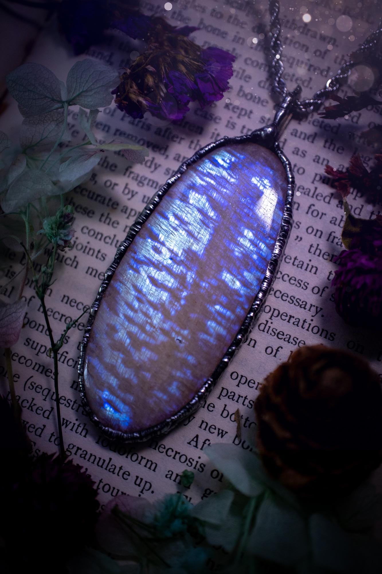 Handmade and beautiful, flashy belomorite, soft soldered pendant necklace. This pendant necklace features the most gorgeous and flashy belomorite moonstone crystal, full of glittery shimmer and a deep lovely blue hue. Handcrafted using the soft solder method, also known as the tiffany technique, an ancient technique used to created stained glass windows. The solder used is lead free and totally safe to wear, it contains elements of silver and polishes up to a high lustre. Gothic witchy jewellery