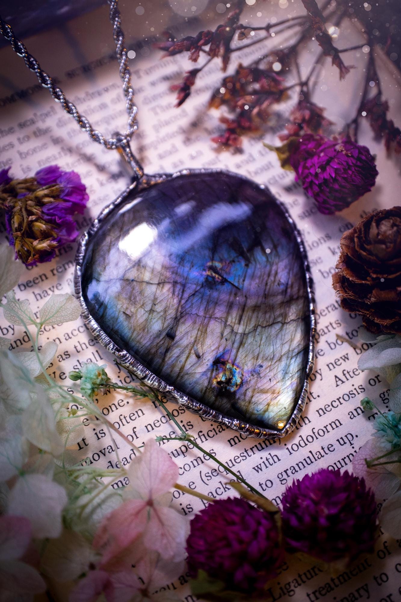 A very unique and one of a kind, soft soldered, labradorite, statement pendant necklace. The labradorite on this pendant is very unique as it is full of silver, purples and blues, with little rainbow clusters. It also has two separate flashing areas on the crystal. Large and beautiful! Handmade using the soft solder method also known as the tiffany technique! This piece of jewellery is a must have for any crystal and jewellery lover, it is full of gothic and witchy vibes! Jewellery for the soul