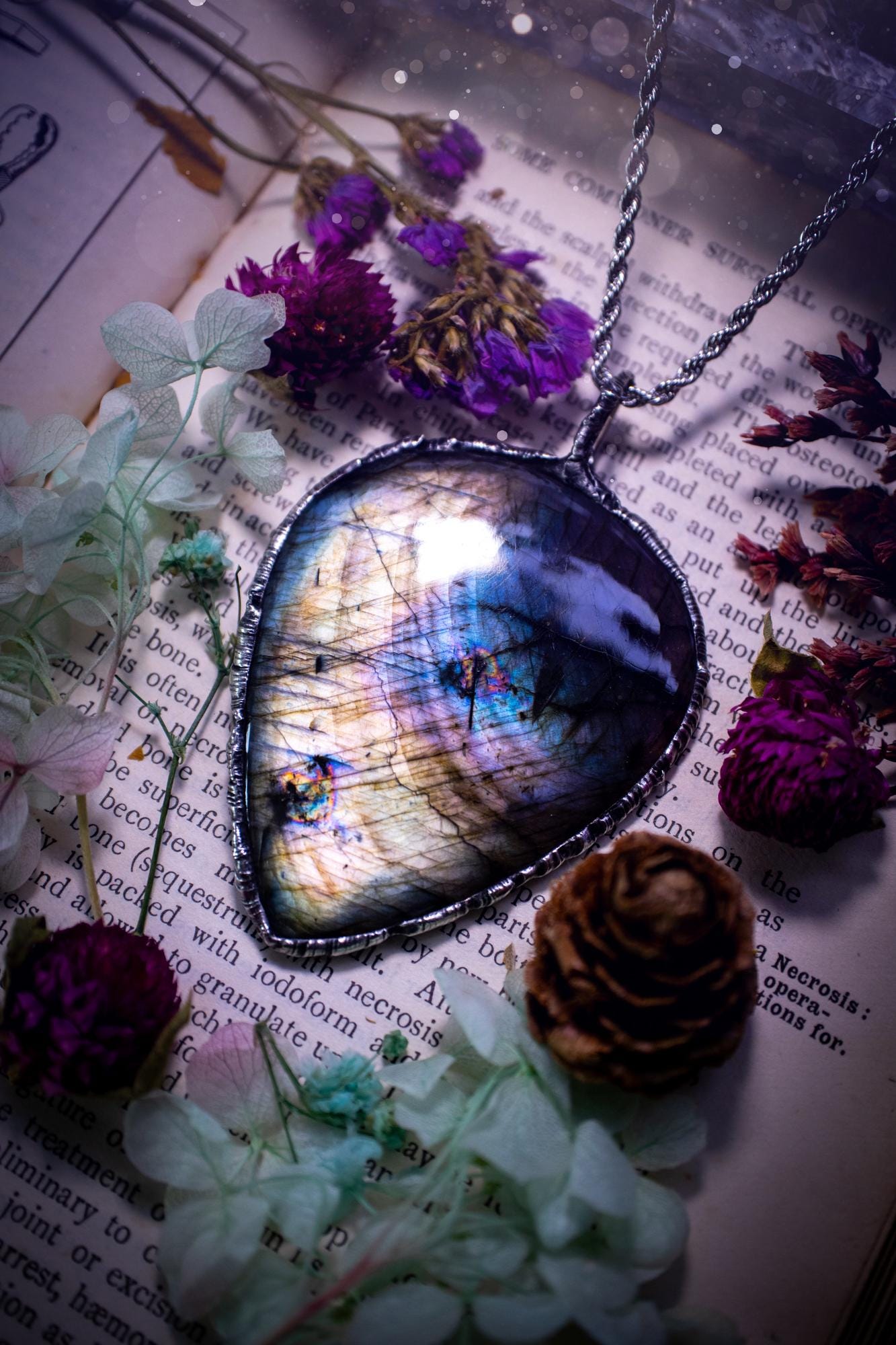 A very unique and one of a kind, soft soldered, labradorite, statement pendant necklace. The labradorite on this pendant is very unique as it is full of silver, purples and blues, with little rainbow clusters. It also has two separate flashing areas on the crystal. Large and beautiful! Handmade using the soft solder method also known as the tiffany technique! This piece of jewellery is a must have for any crystal and jewellery lover, it is full of gothic and witchy vibes! Jewellery for the soul