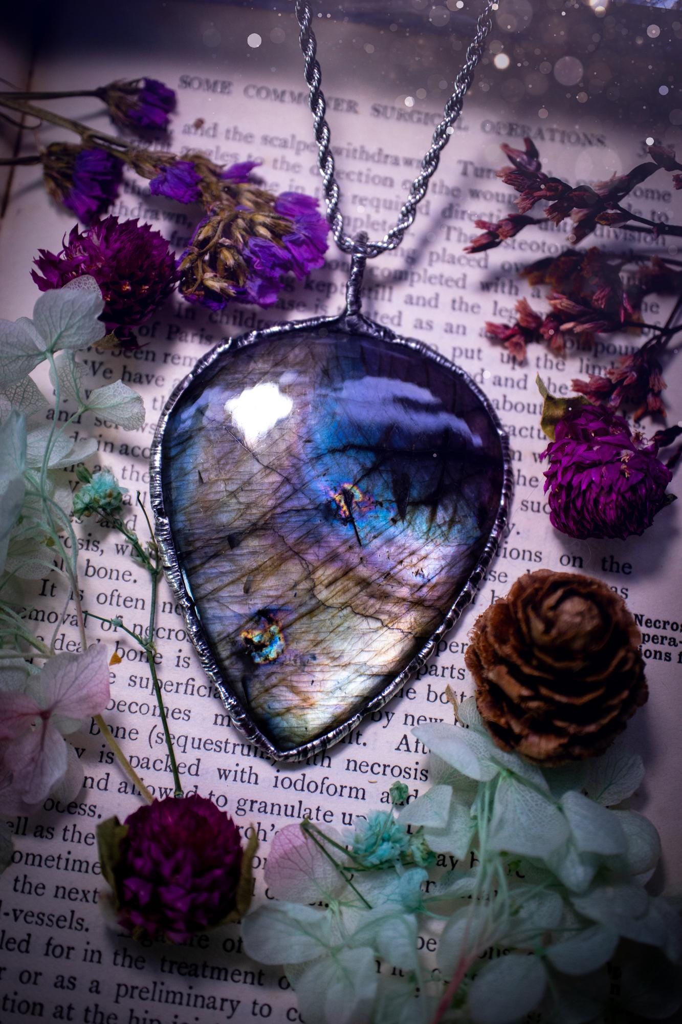 A very unique and one of a kind, soft soldered, labradorite, statement pendant necklace. The labradorite on this pendant is very unique as it is full of silver, purples and blues, with little rainbow clusters. It also has two separate flashing areas on the crystal. Large and beautiful! Handmade using the soft solder method also known as the tiffany technique! This piece of jewellery is a must have for any crystal and jewellery lover, it is full of gothic and witchy vibes! Jewellery for the soul
