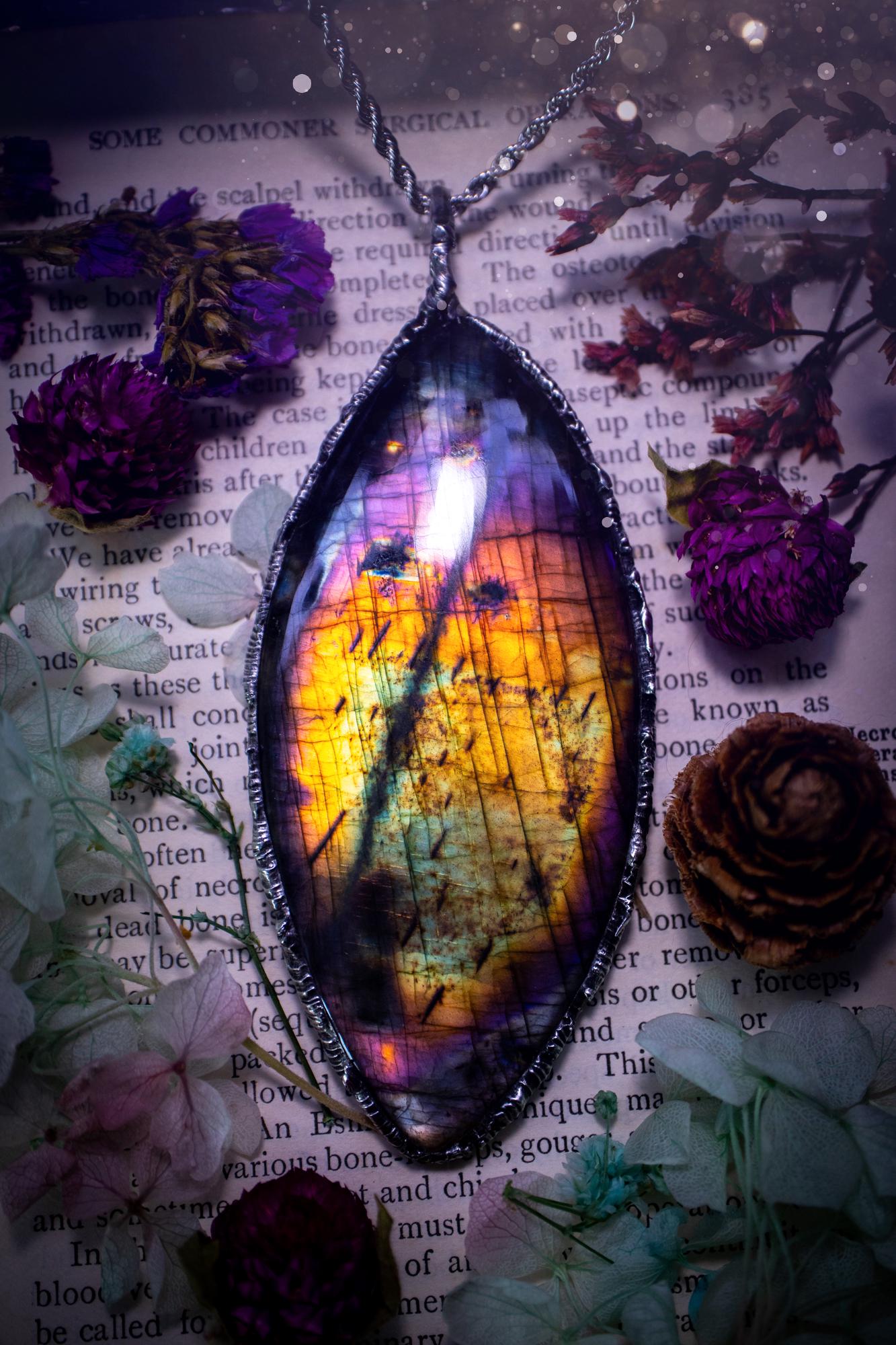 A very unique and one of a kind, soft soldered, labradorite, statement pendant necklace. The labradorite on this pendant is very unique as it is full of rainbow hues and is very large in size. Handmade using the soft solder method also known as the tiffany technique! This piece of jewellery is a must have for any crystal and jewellery lover, it is full of gothic and witchy vibes! Jewellery for the soul