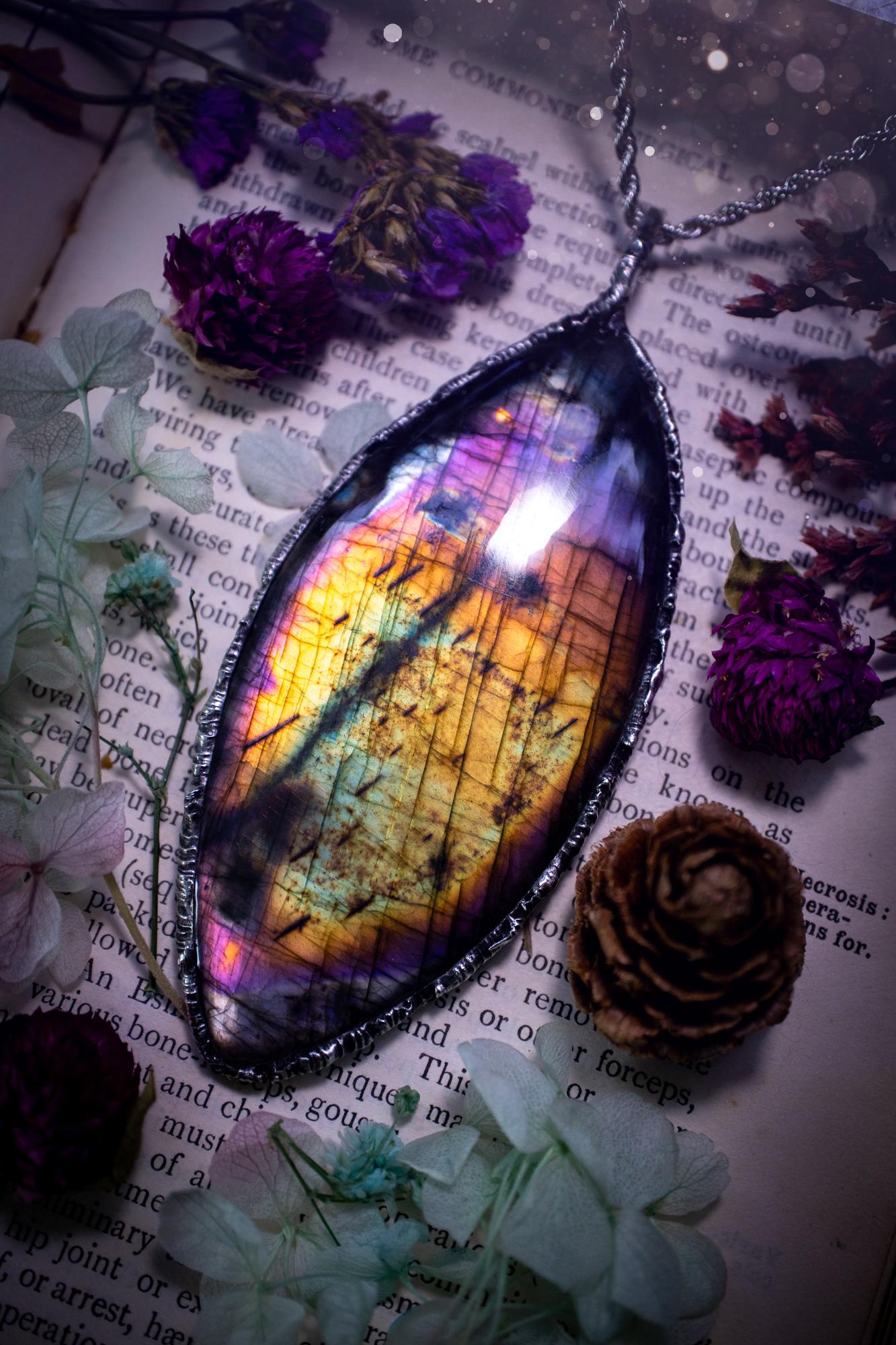 A very unique and one of a kind, soft soldered, labradorite, statement pendant necklace. The labradorite on this pendant is very unique as it is full of rainbow hues and is very large in size. Handmade using the soft solder method also known as the tiffany technique! This piece of jewellery is a must have for any crystal and jewellery lover, it is full of gothic and witchy vibes! Jewellery for the soul