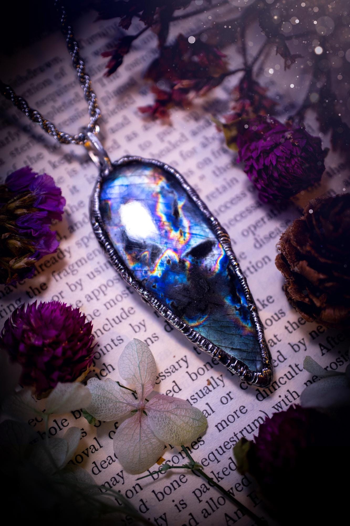 A very unique and one of a kind, soft soldered, labradorite, pendant necklace. The labradorite on this pendant is very unique as it is full of green, purples and blues, with little rainbow clusters. It also has two separate flashing areas on the crystal. Very vibrant and beautiful! Handmade using the soft solder method also known as the tiffany technique! This piece of jewellery is a must have for any crystal and jewellery lover, it is full of gothic and witchy vibes! Jewellery for the soul