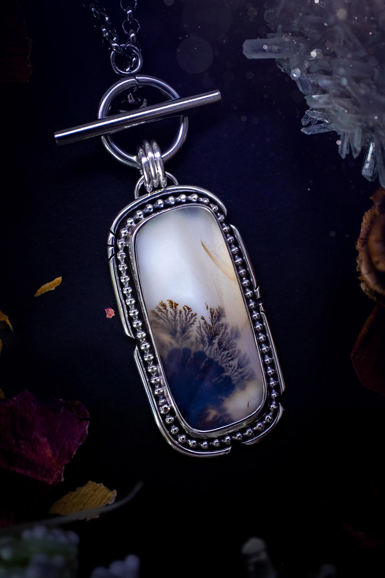Stunning, bespoke and natural, scenic dendritic agate, sterling silver statement pendant necklace. This pendant necklace has been handmade using fine and sterling silver. It features a beautiful scenic dendritic agate that has a beautiful pattern that looks similar to little trees, a very unique and one of a kind jewellery piece. Around the crystal is a smooth bezel with smooth and beaded wire. A lovely gift for any crystal and jewellery lover. This piece has a witchy and gothic vibes, hippy.