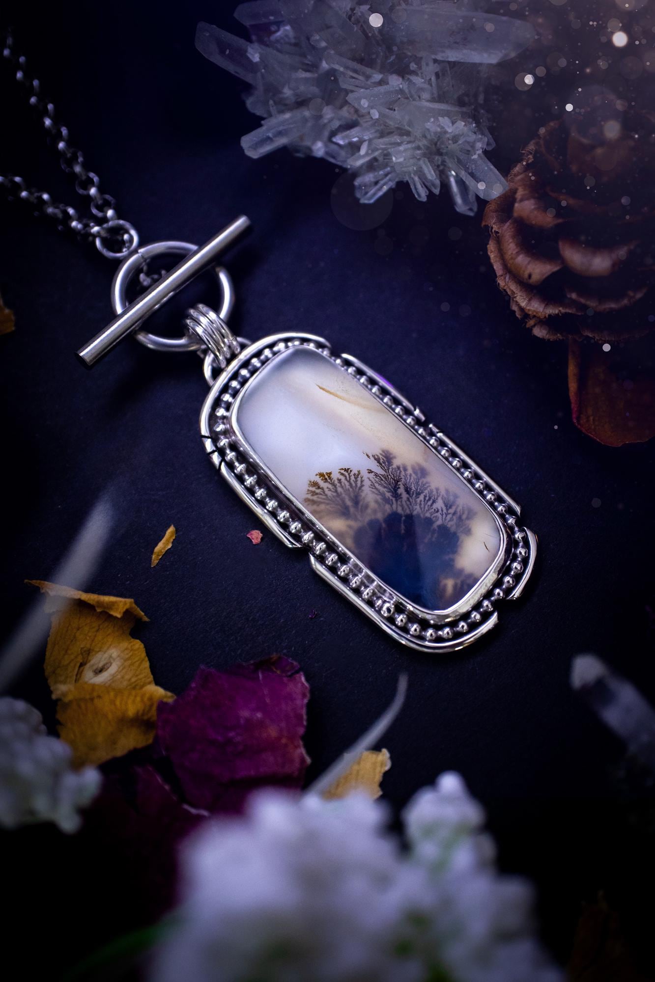 Stunning, bespoke and natural, scenic dendritic agate, sterling silver statement pendant necklace. This pendant necklace has been handmade using fine and sterling silver. It features a beautiful scenic dendritic agate that has a beautiful pattern that looks similar to little trees, a very unique and one of a kind jewellery piece. Around the crystal is a smooth bezel with smooth and beaded wire. A lovely gift for any crystal and jewellery lover. This piece has a witchy and gothic vibes, hippy.