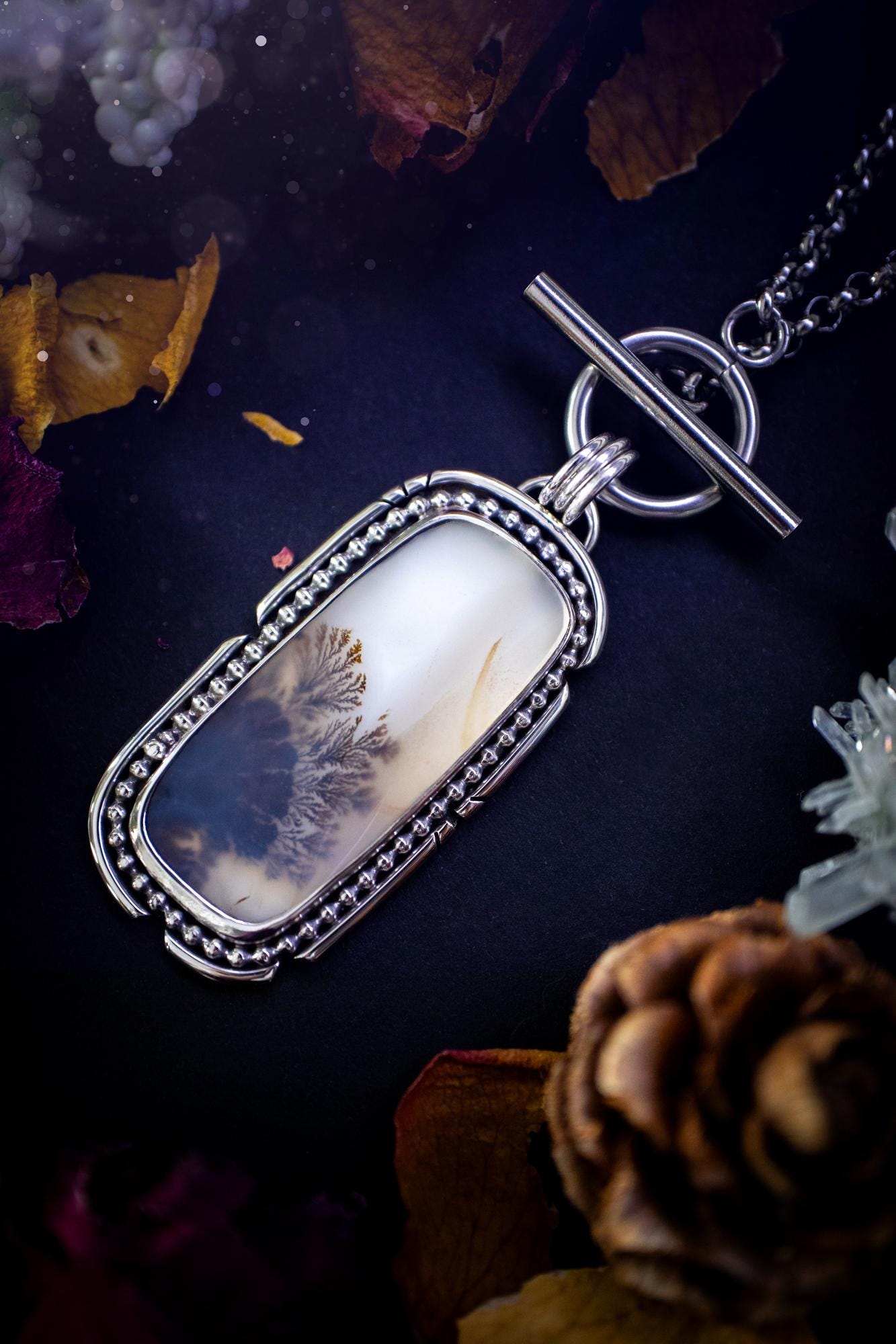 Stunning, bespoke and natural, scenic dendritic agate, sterling silver statement pendant necklace. This pendant necklace has been handmade using fine and sterling silver. It features a beautiful scenic dendritic agate that has a beautiful pattern that looks similar to little trees, a very unique and one of a kind jewellery piece. Around the crystal is a smooth bezel with smooth and beaded wire. A lovely gift for any crystal and jewellery lover. This piece has a witchy and gothic vibes, hippy.