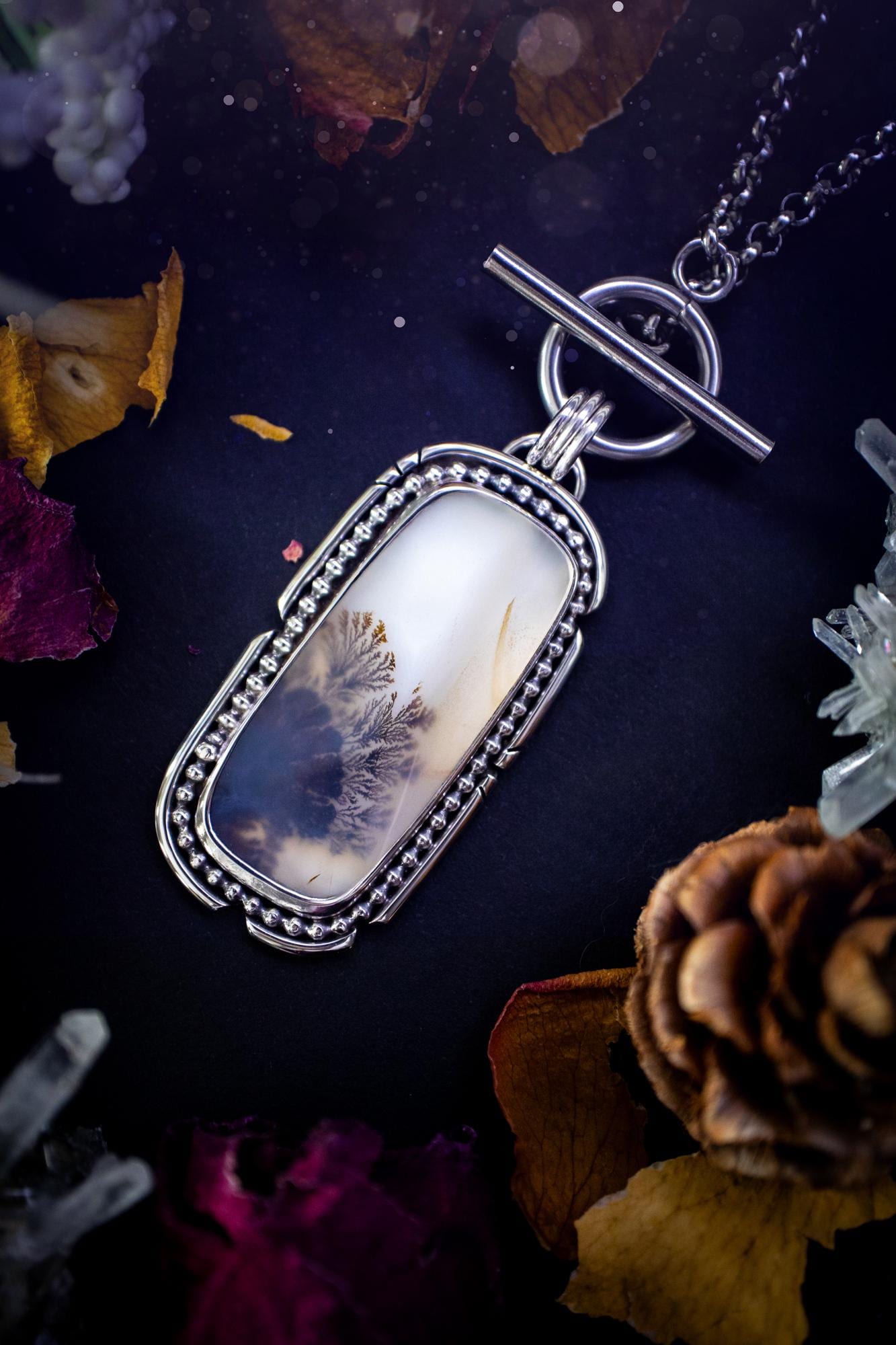 Stunning, bespoke and natural, scenic dendritic agate, sterling silver statement pendant necklace. This pendant necklace has been handmade using fine and sterling silver. It features a beautiful scenic dendritic agate that has a beautiful pattern that looks similar to little trees, a very unique and one of a kind jewellery piece. Around the crystal is a smooth bezel with smooth and beaded wire. A lovely gift for any crystal and jewellery lover. This piece has a witchy and gothic vibes, hippy.