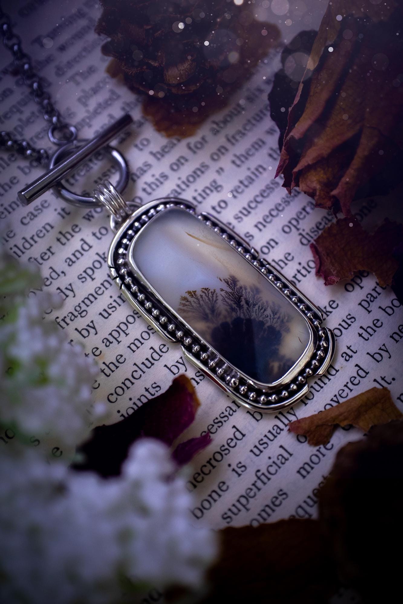 Stunning, bespoke and natural, scenic dendritic agate, sterling silver statement pendant necklace. This pendant necklace has been handmade using fine and sterling silver. It features a beautiful scenic dendritic agate that has a beautiful pattern that looks similar to little trees, a very unique and one of a kind jewellery piece. Around the crystal is a smooth bezel with smooth and beaded wire. A lovely gift for any crystal and jewellery lover. This piece has a witchy and gothic vibes, hippy.