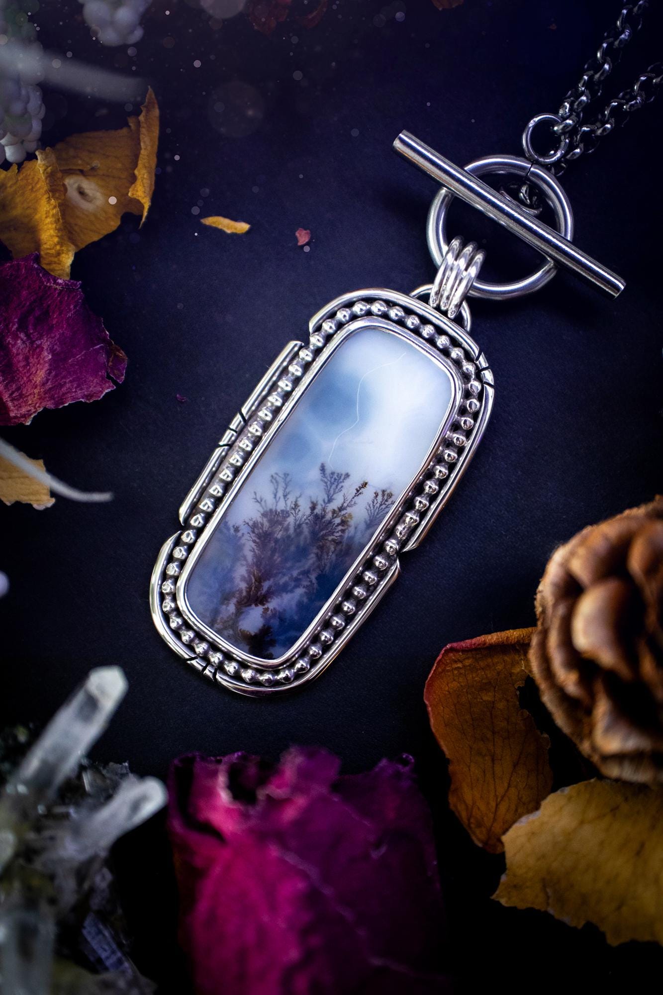Stunning, bespoke and natural, scenic dendritic agate, sterling silver statement pendant necklace. This pendant necklace has been handmade using fine and sterling silver. It features a beautiful scenic dendritic agate that has a beautiful pattern that looks similar to little trees, a very unique and one of a kind jewellery piece. Around the crystal is a smooth bezel with smooth and beaded wire. A lovely gift for any crystal and jewellery lover. This piece has a witchy and gothic vibes, hippy.