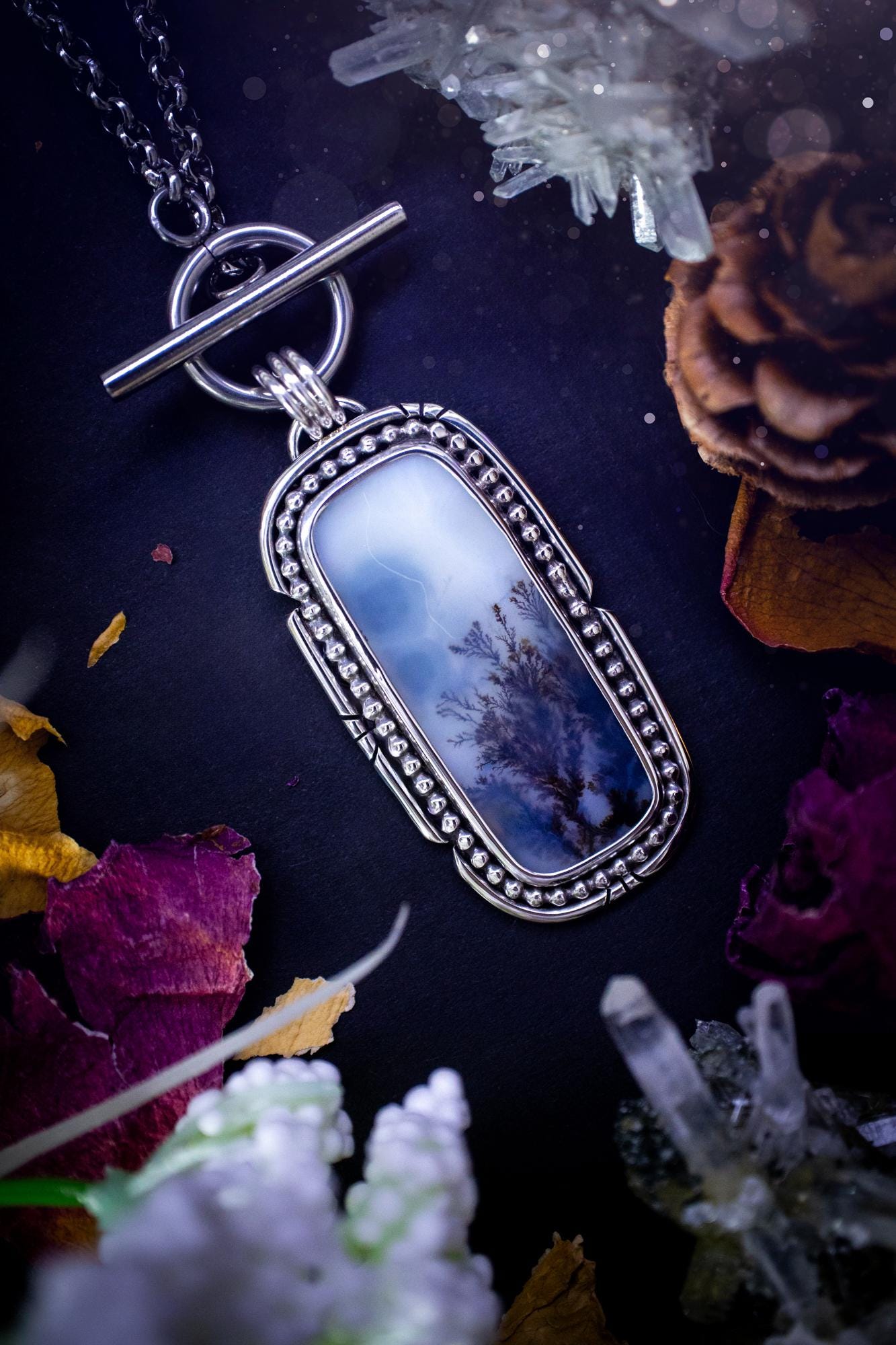 Stunning, bespoke and natural, scenic dendritic agate, sterling silver statement pendant necklace. This pendant necklace has been handmade using fine and sterling silver. It features a beautiful scenic dendritic agate that has a beautiful pattern that looks similar to little trees, a very unique and one of a kind jewellery piece. Around the crystal is a smooth bezel with smooth and beaded wire. A lovely gift for any crystal and jewellery lover. This piece has a witchy and gothic vibes, hippy.